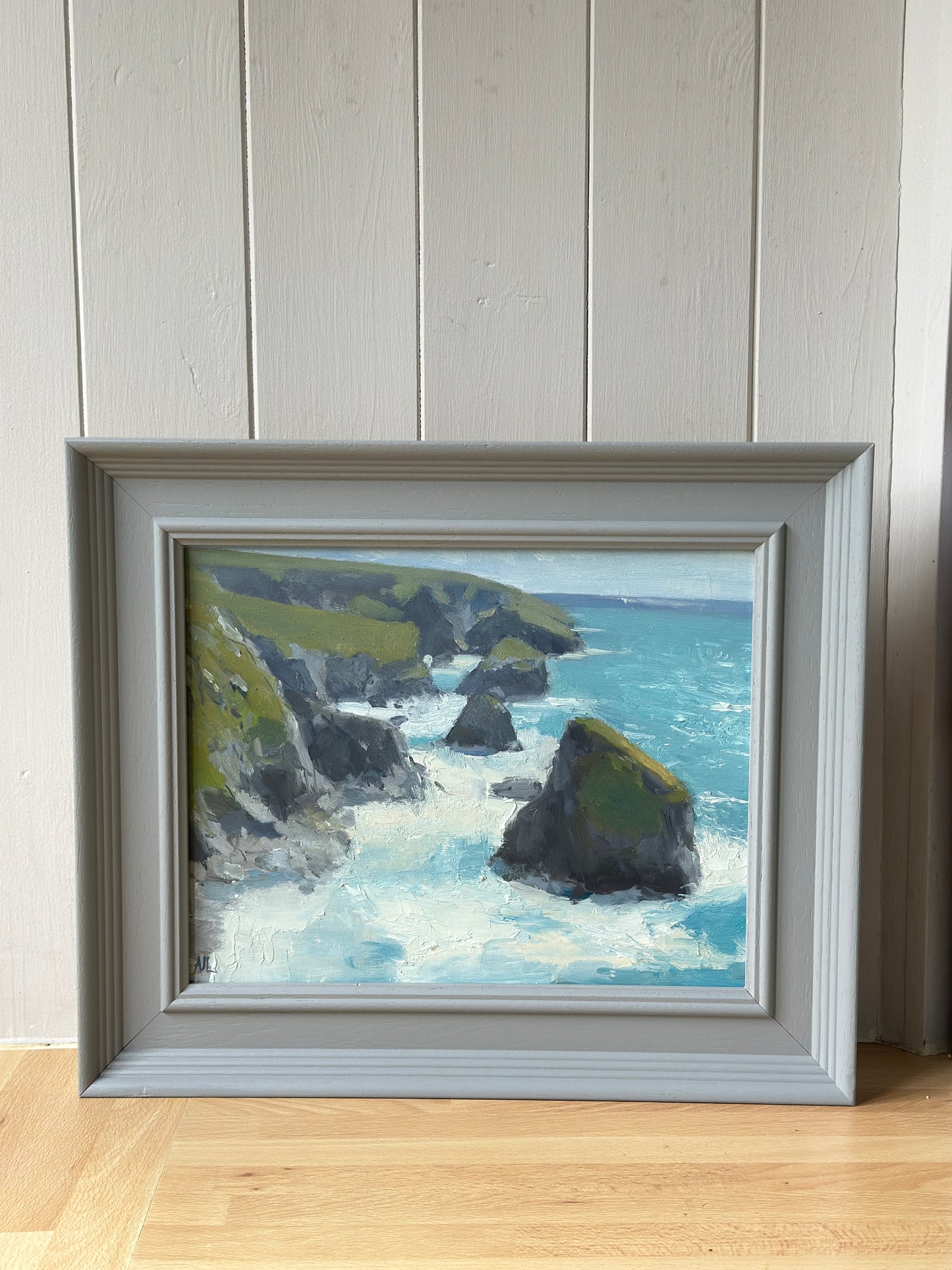 The original oil painting in a grey frame.