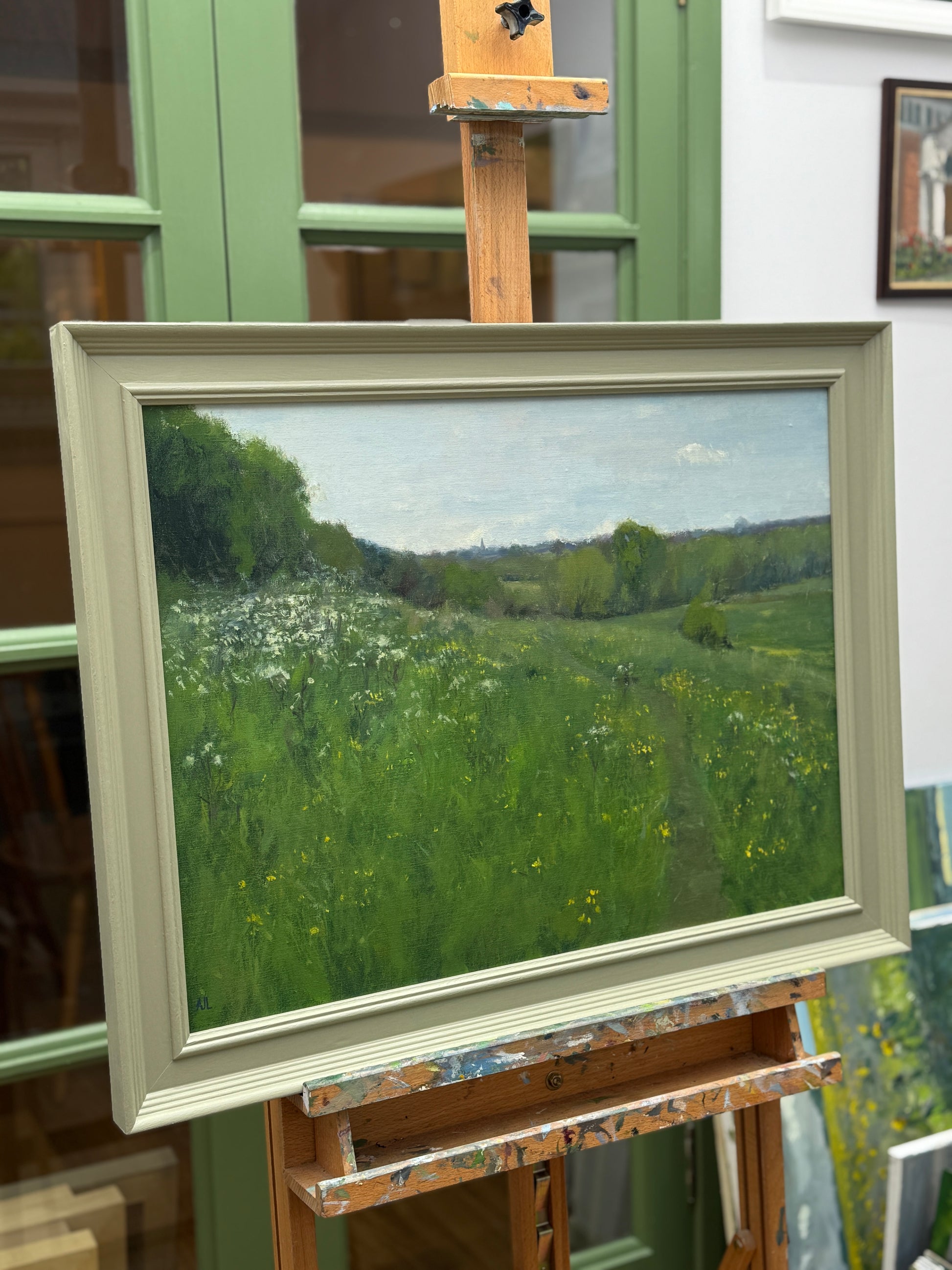 The artwork viewed from the side, while framed on an easel.