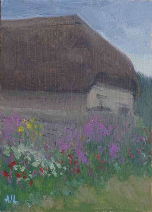 An original oil painting of a traditional thatched-roof cottage in the Cotswolds, at Cogges Manor Farm. The cloudless sky is blue above the building, and in the foreground, flowers are blooming against a wall, in a riot of purple, yellow, white and red.  The artist has signed AJL in light blue, for "Alex James Long", at the bottom left of the artwork.