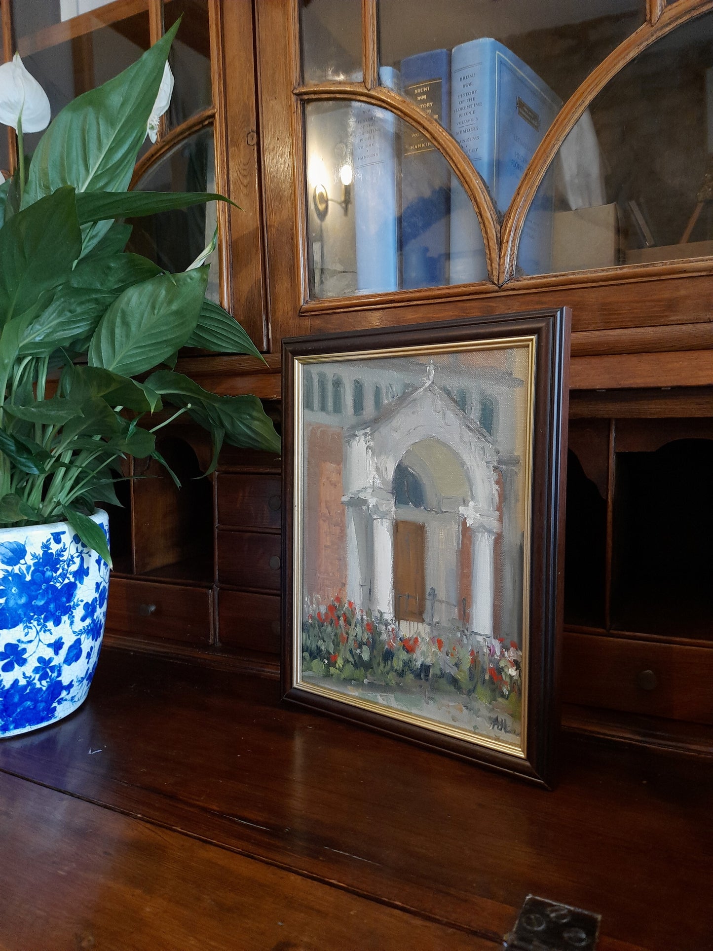 The framed oil painting as seen from the side.