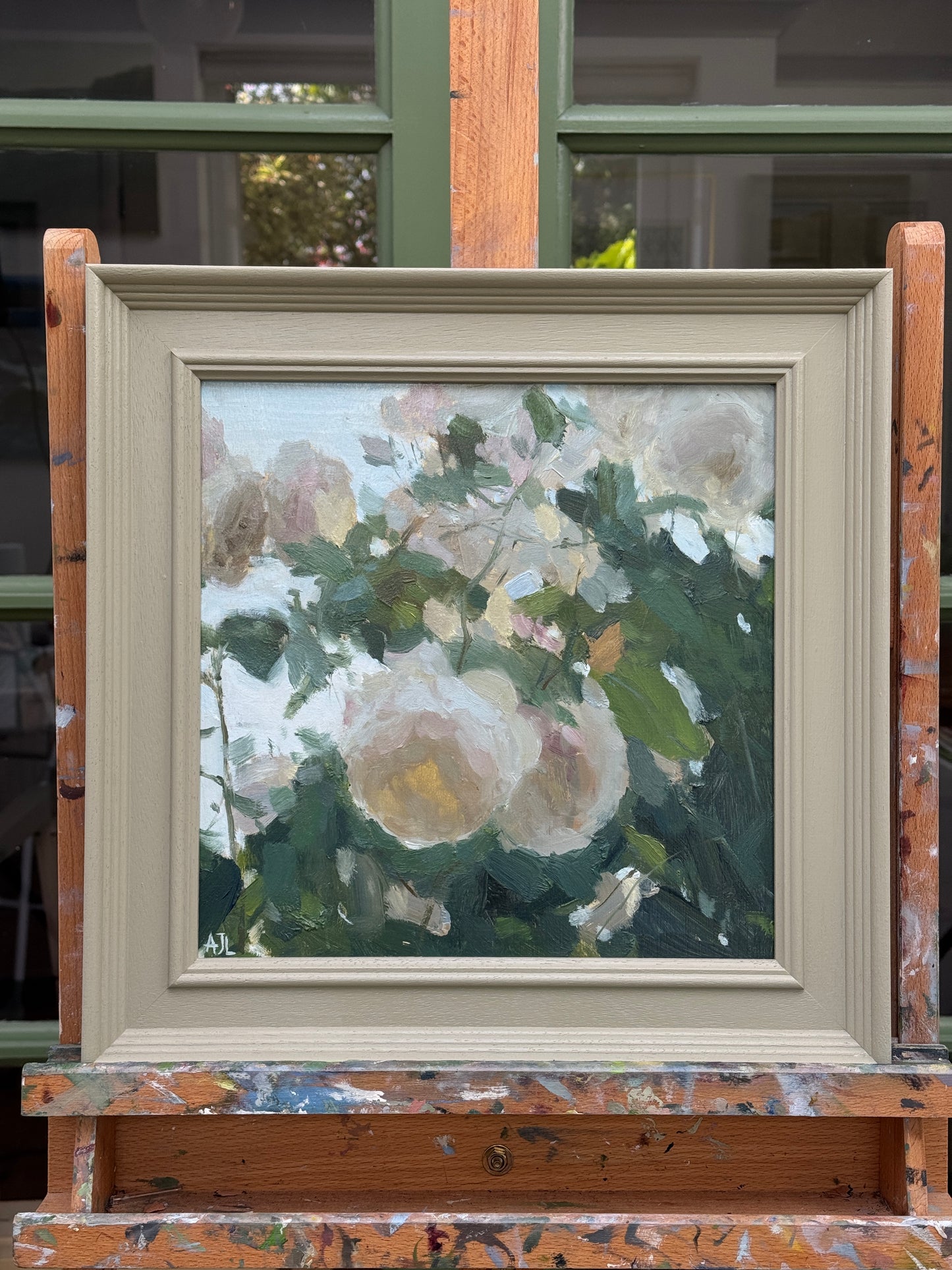 The original artwork in a painted wooden frame.