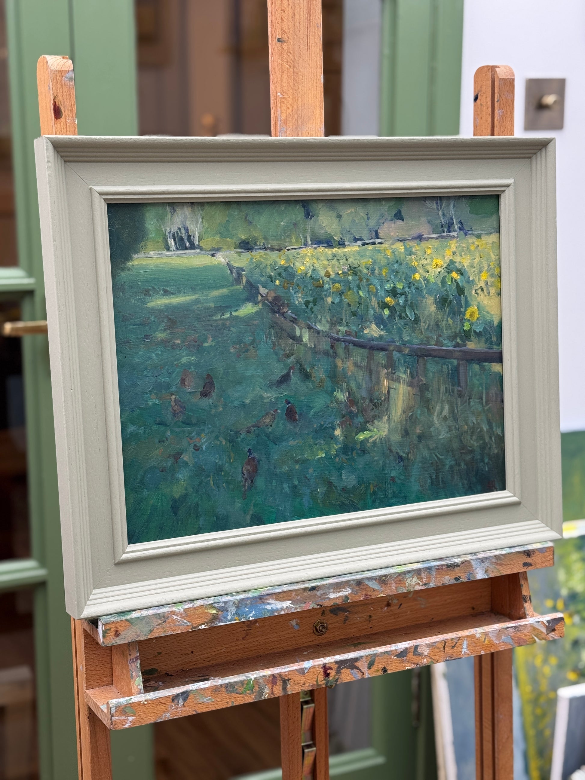 The original oil painting on an easel as seen from the side.