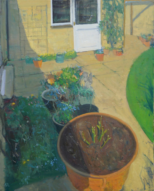 An original oil painting of a corner of a back garden with spring plants in terracotta pots, including a large pot with a bare root rose growing in the foreground. The artist has signed AJL in blue, for "Alex James Long", at the bottom left of the artwork.