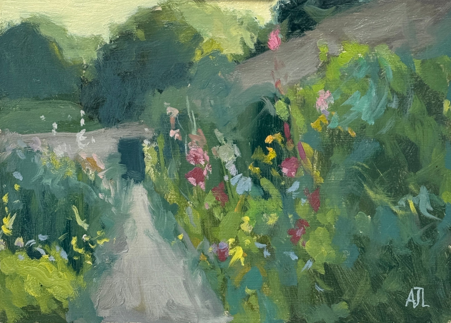An original oil painting of the walled garden at Cogges Manor Farm, with colourful hollyhocks surrounding both sides of a path in the middle of the painting. The artist has signed AJL in blue, for "Alex James Long", at the bottom right of the artwork.