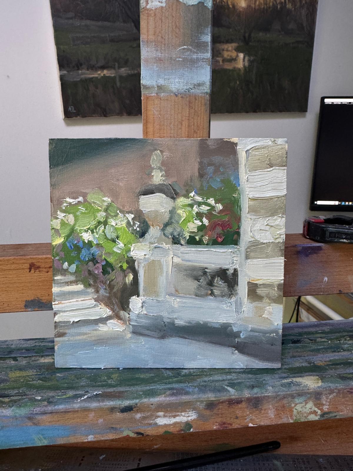 A photo of the unsigned painting on an easel in the artist's studio.