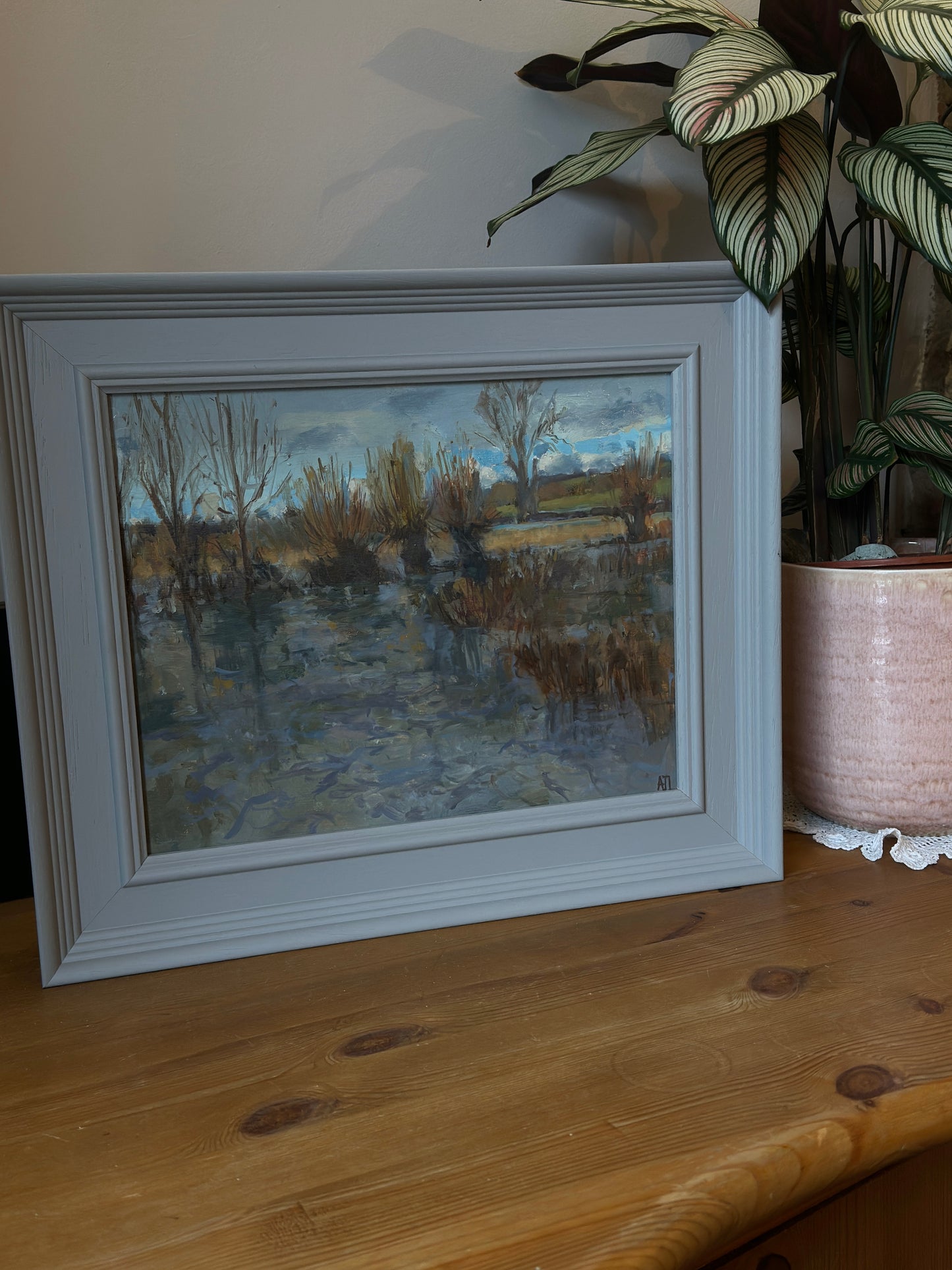 The original oil painting in a grey frame.