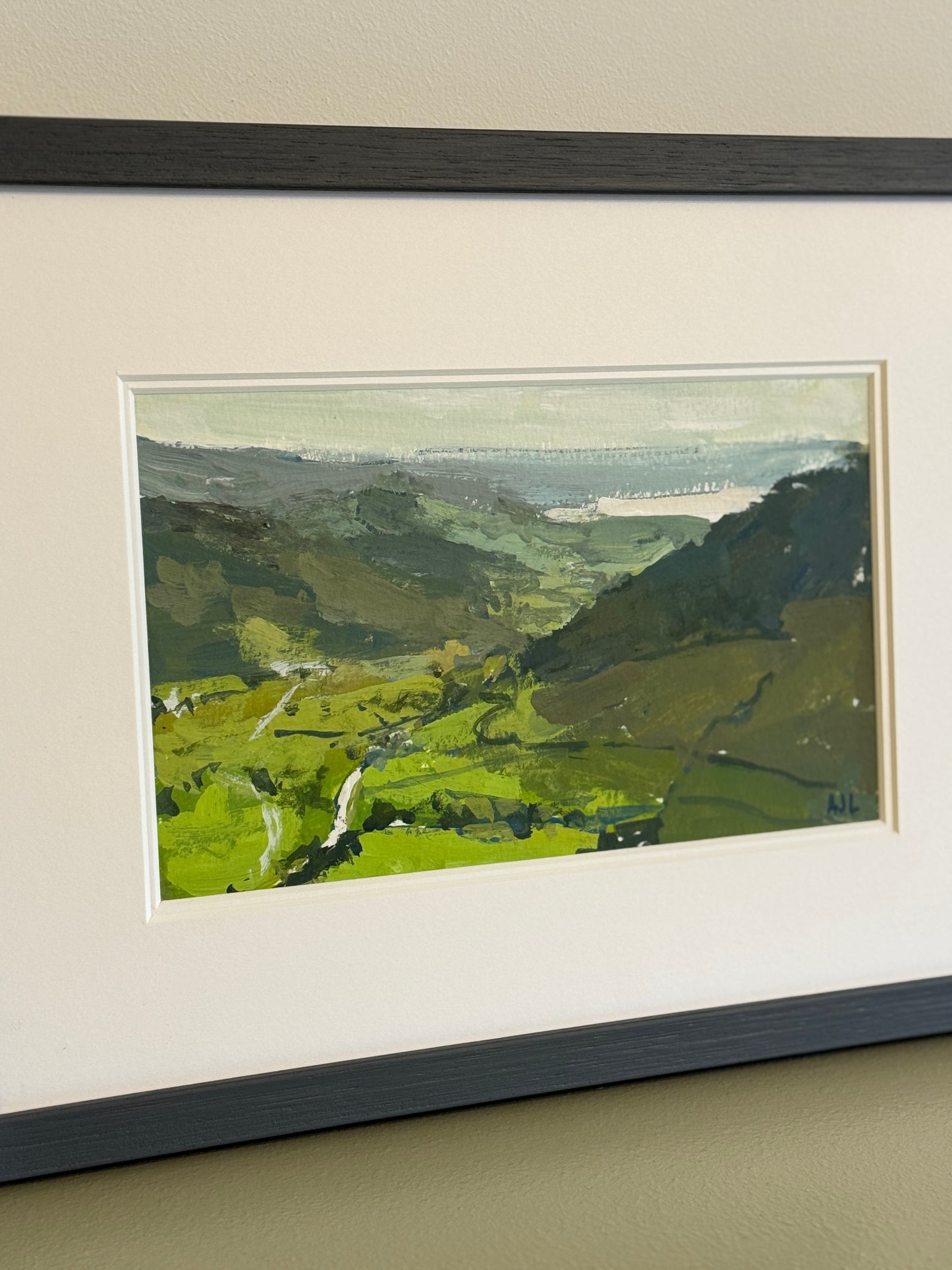 A side view of the framed painting.