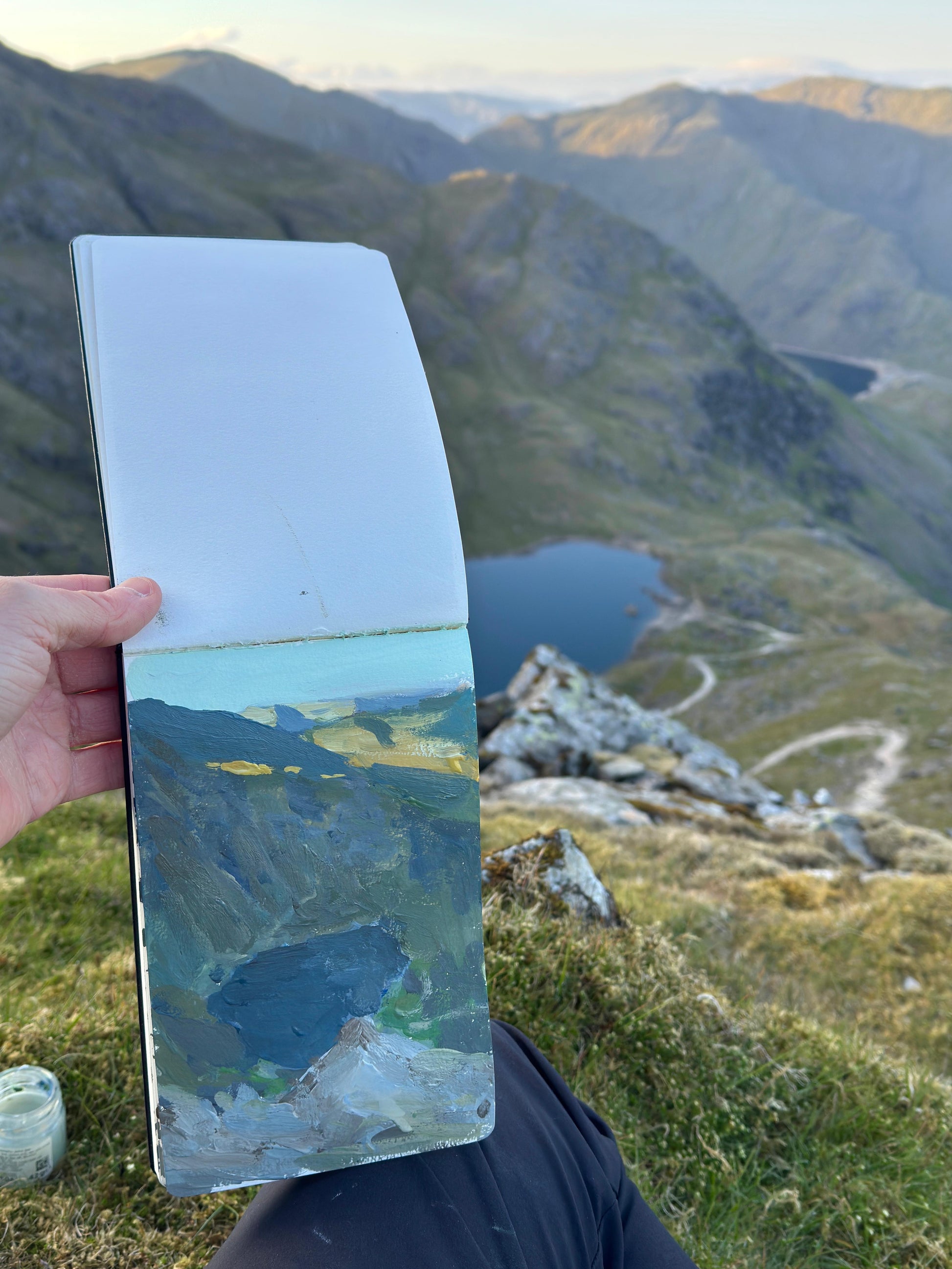 Just catching the evening light at the top of a Lake District pike, a photo of the view and the artwork still in the Moleskine sketchpad.