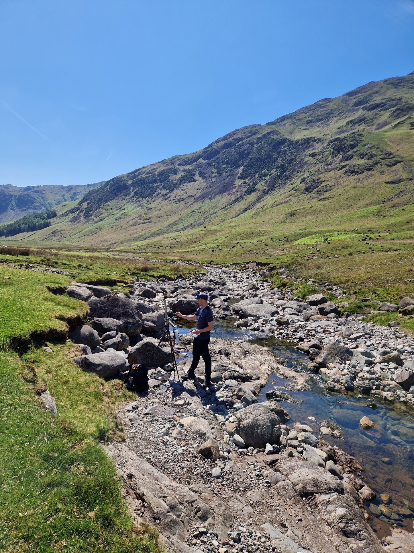 Painting the artwork from directly within the riverbed.