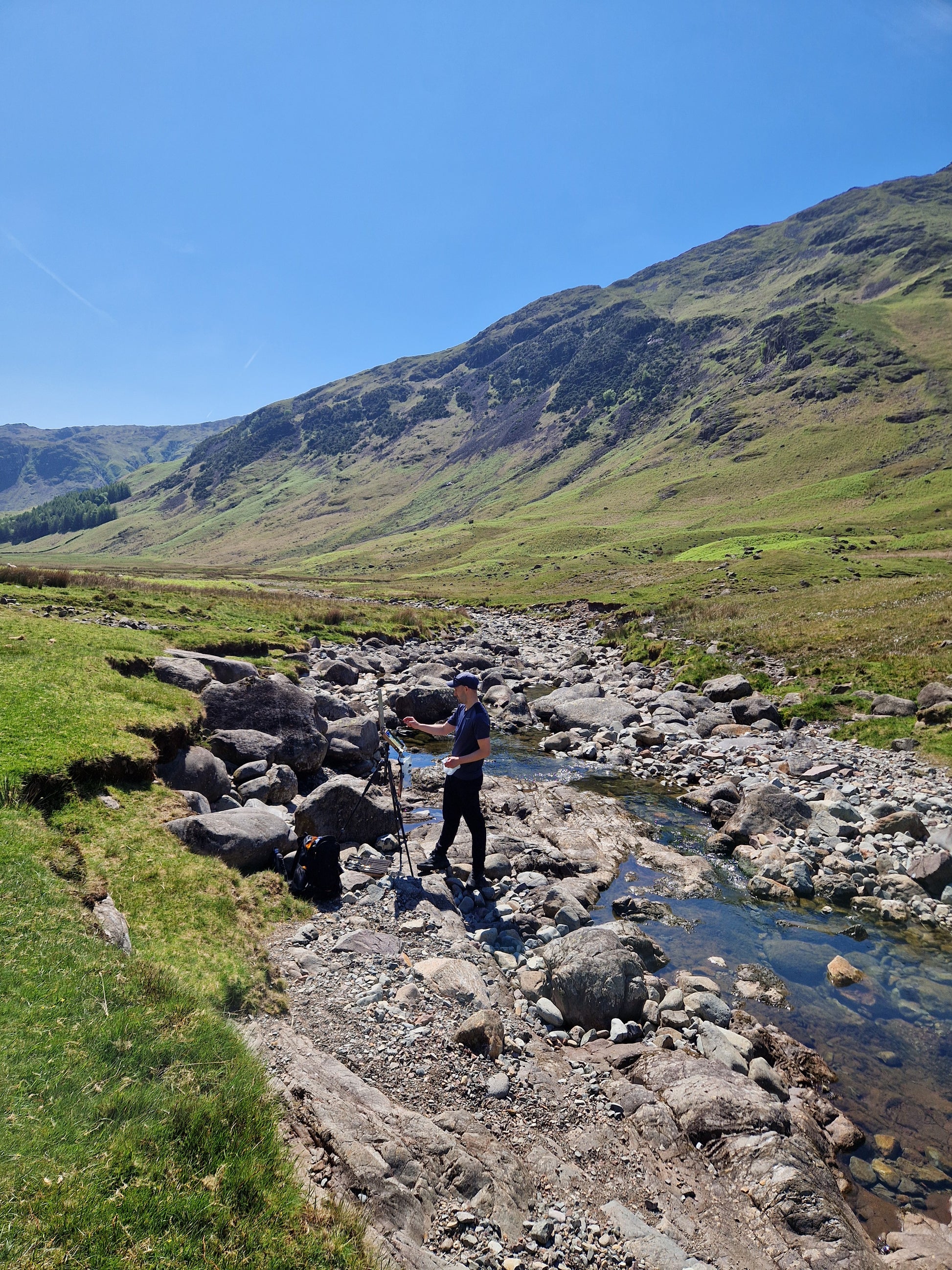 Painting the artwork from directly within the riverbed.