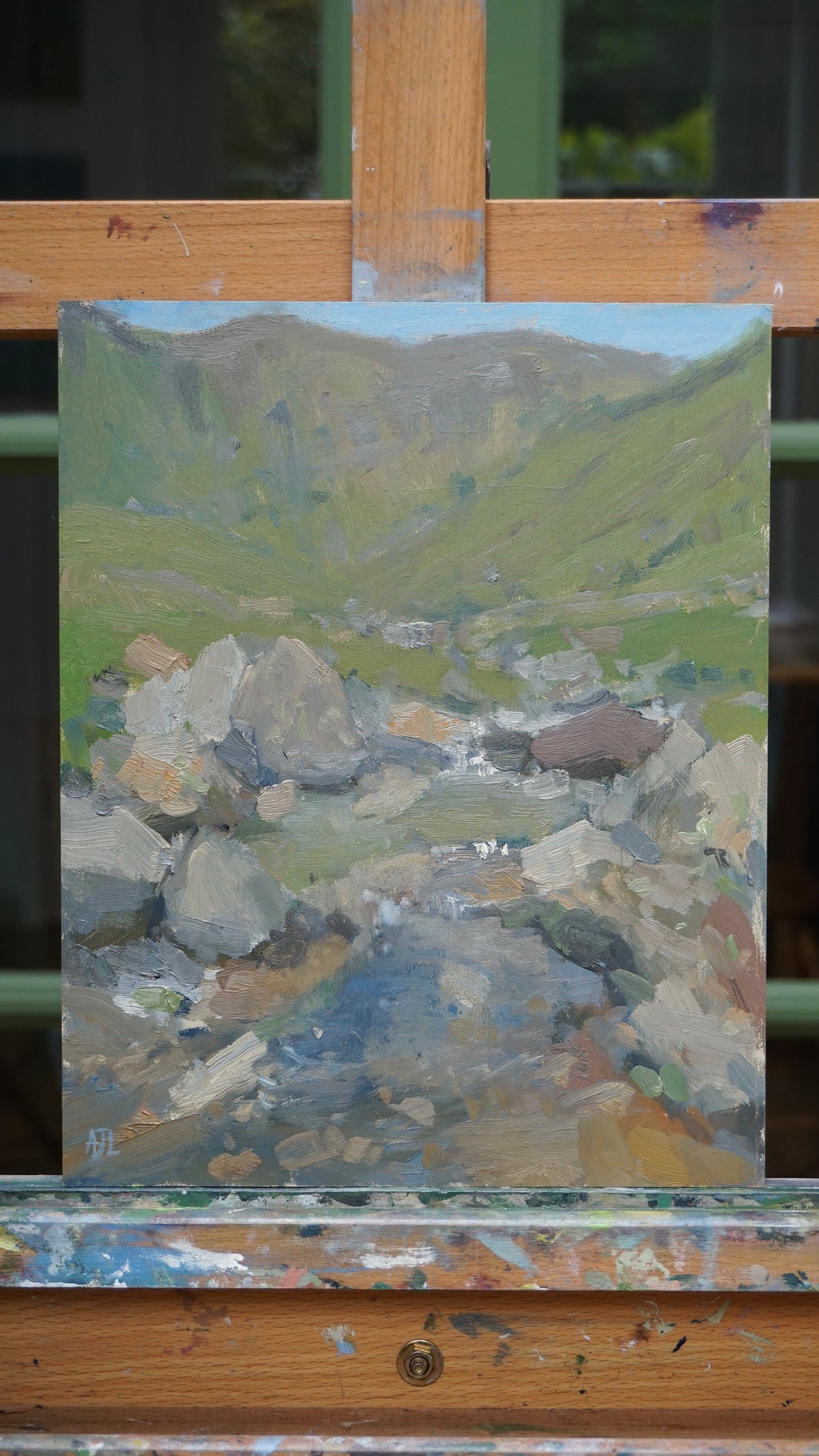 The original painting on an easel.