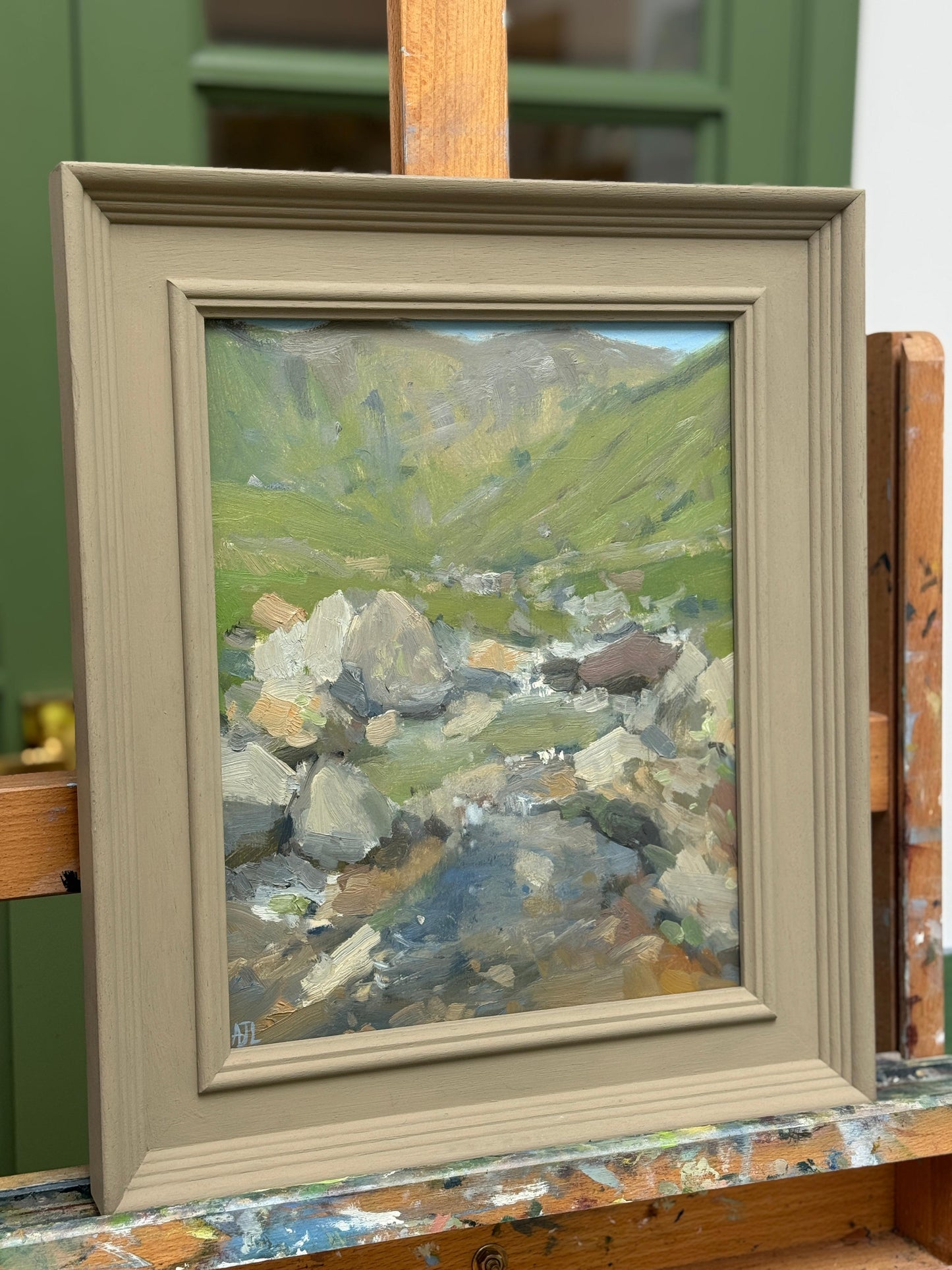 The oil painting on an easel.