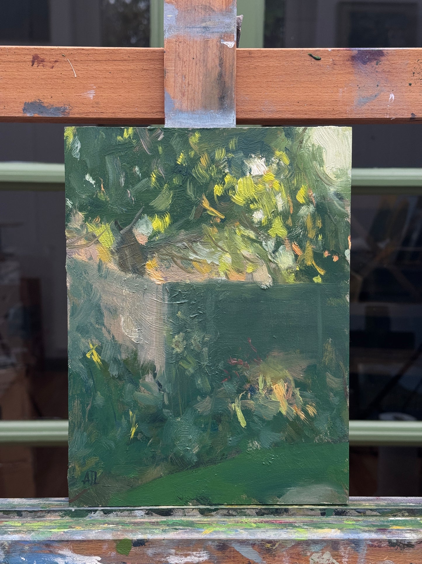 The painting resting on the artist easel.