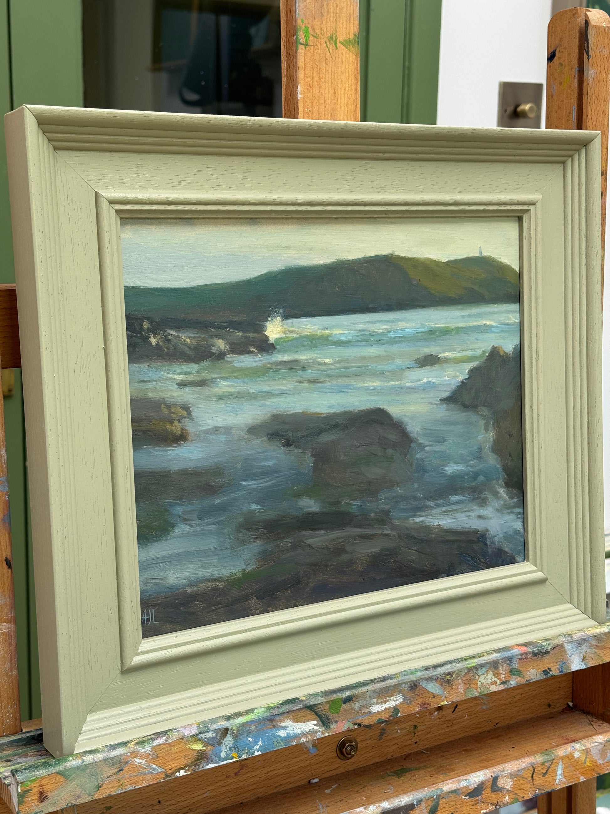 A side view of the oil painting in the wood frame.