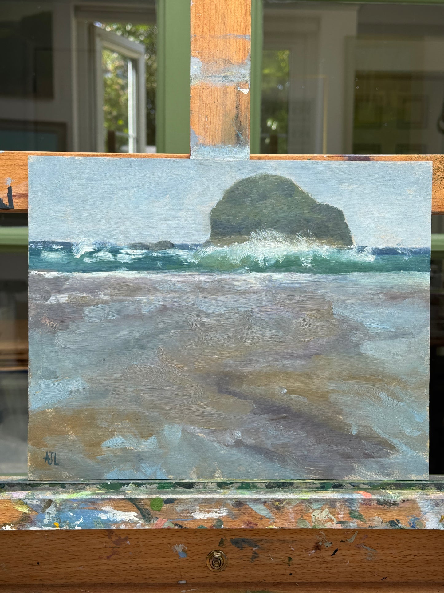 The artwork resting on the artist easel.