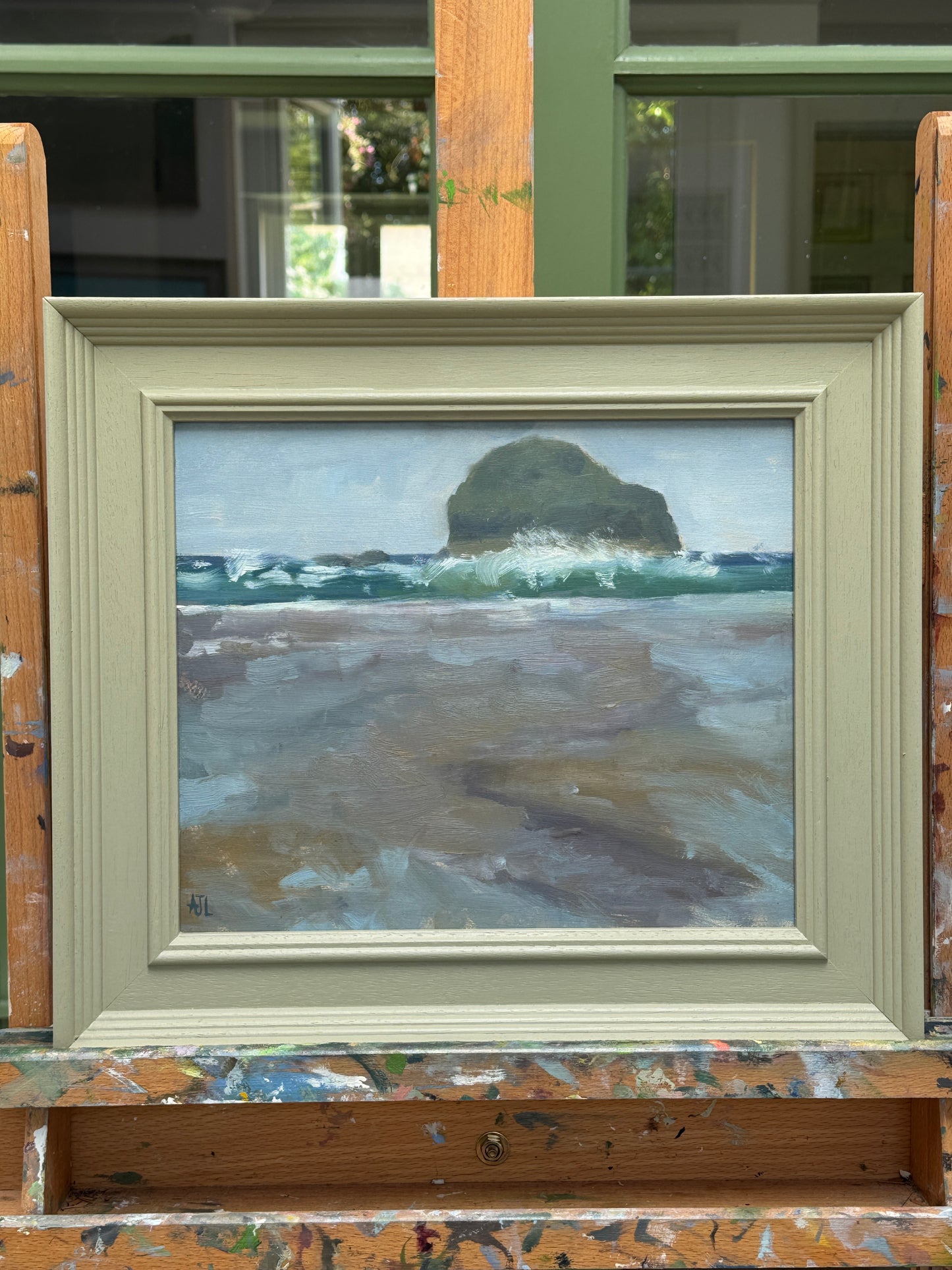 The artwork presented in a green painted frame.