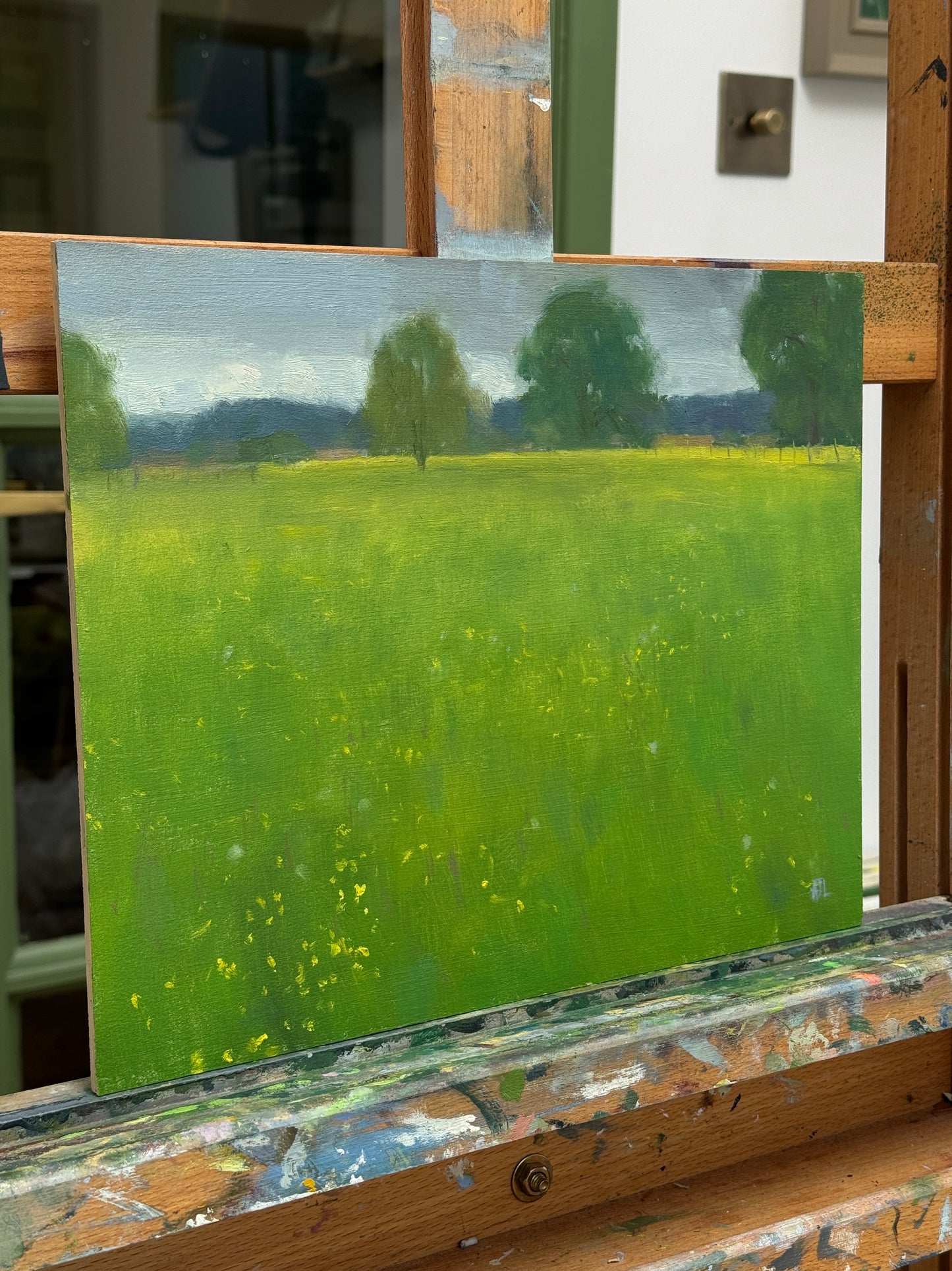 A photograph of the painting from the side as it sits on the artist easel.