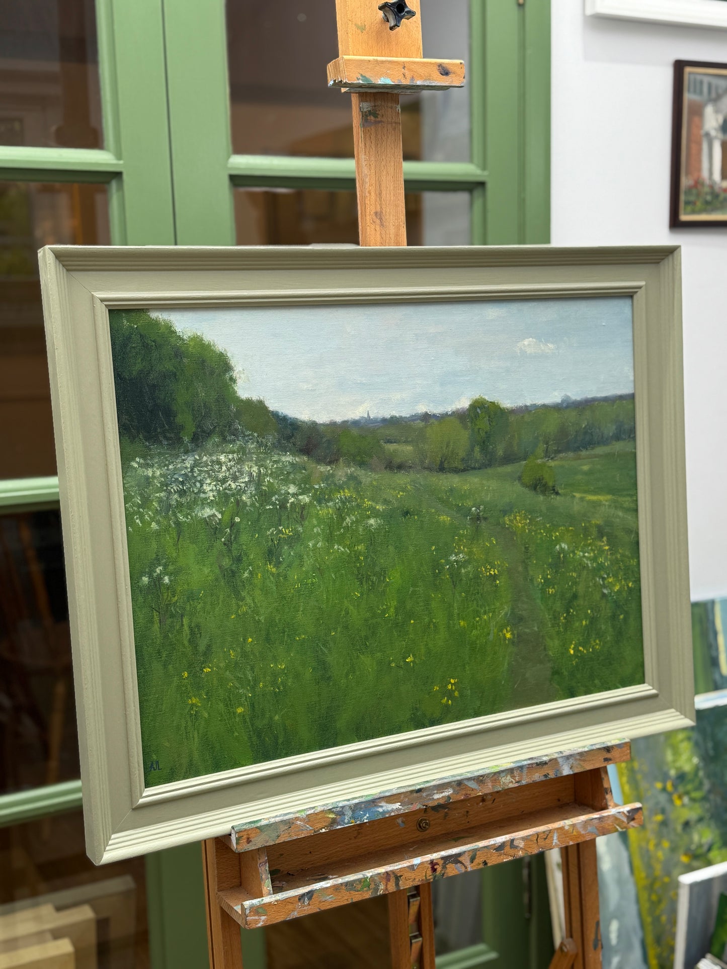 The artwork viewed from the side, while framed on an easel.
