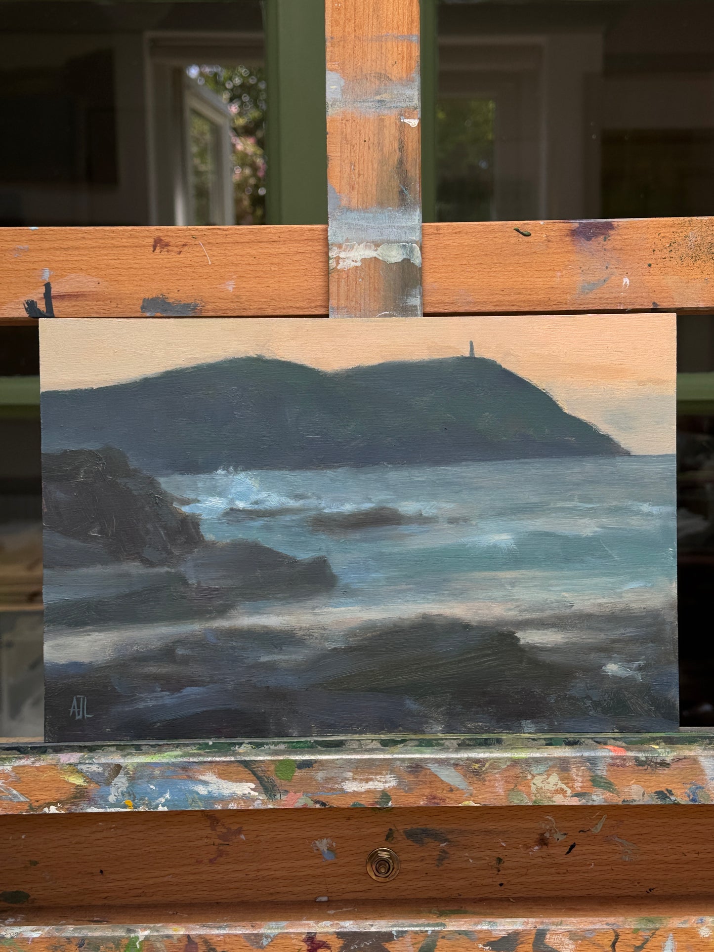 The painting, resting on the artist easel.