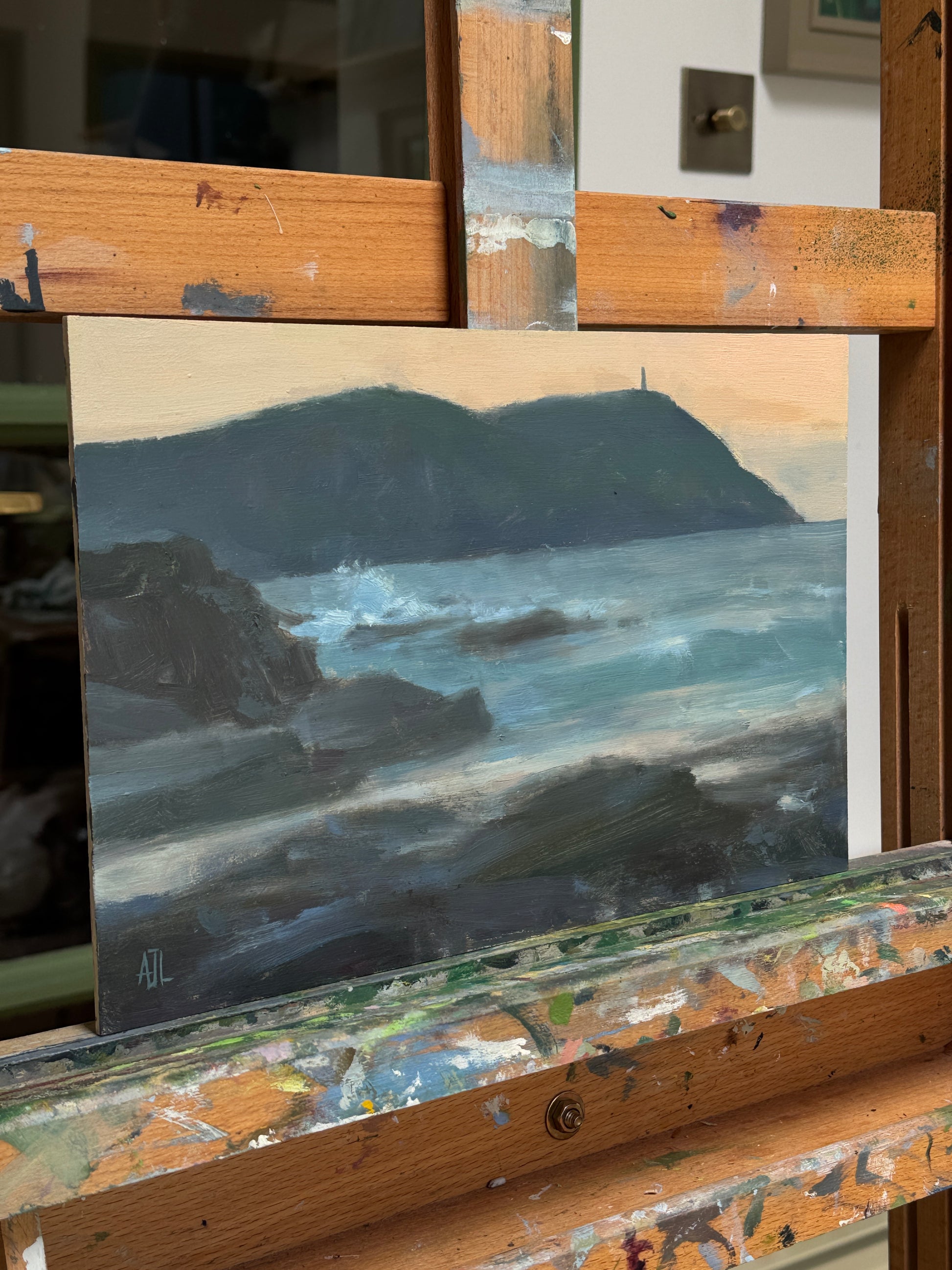 A side view of the artwork while it rests on the artist easel.
