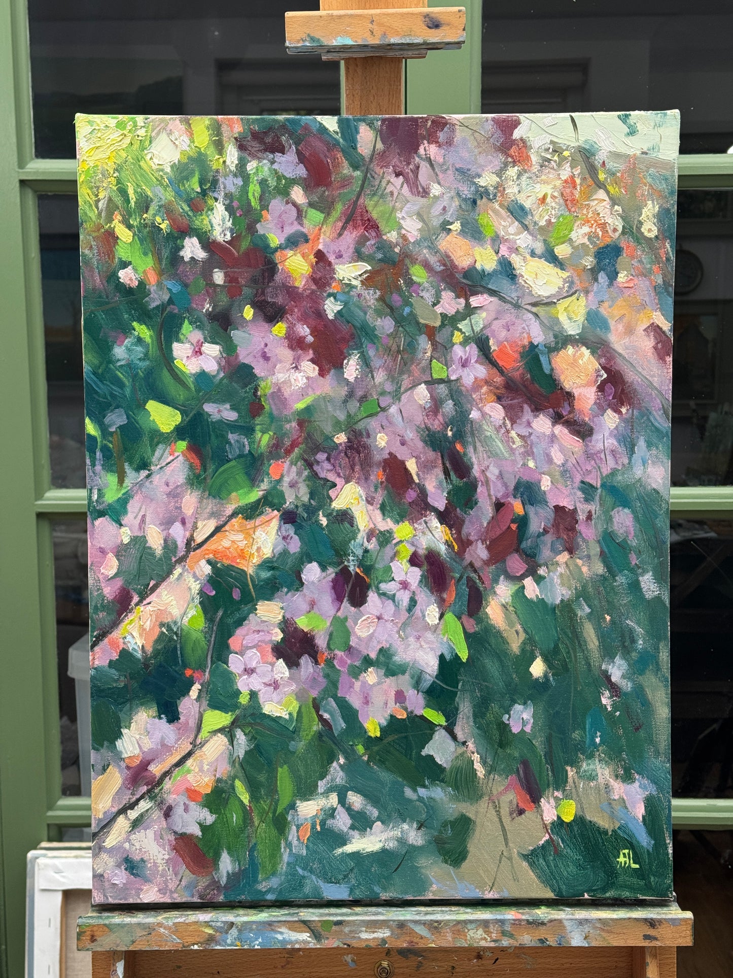 The large oil painting resting on the artist's easel.
