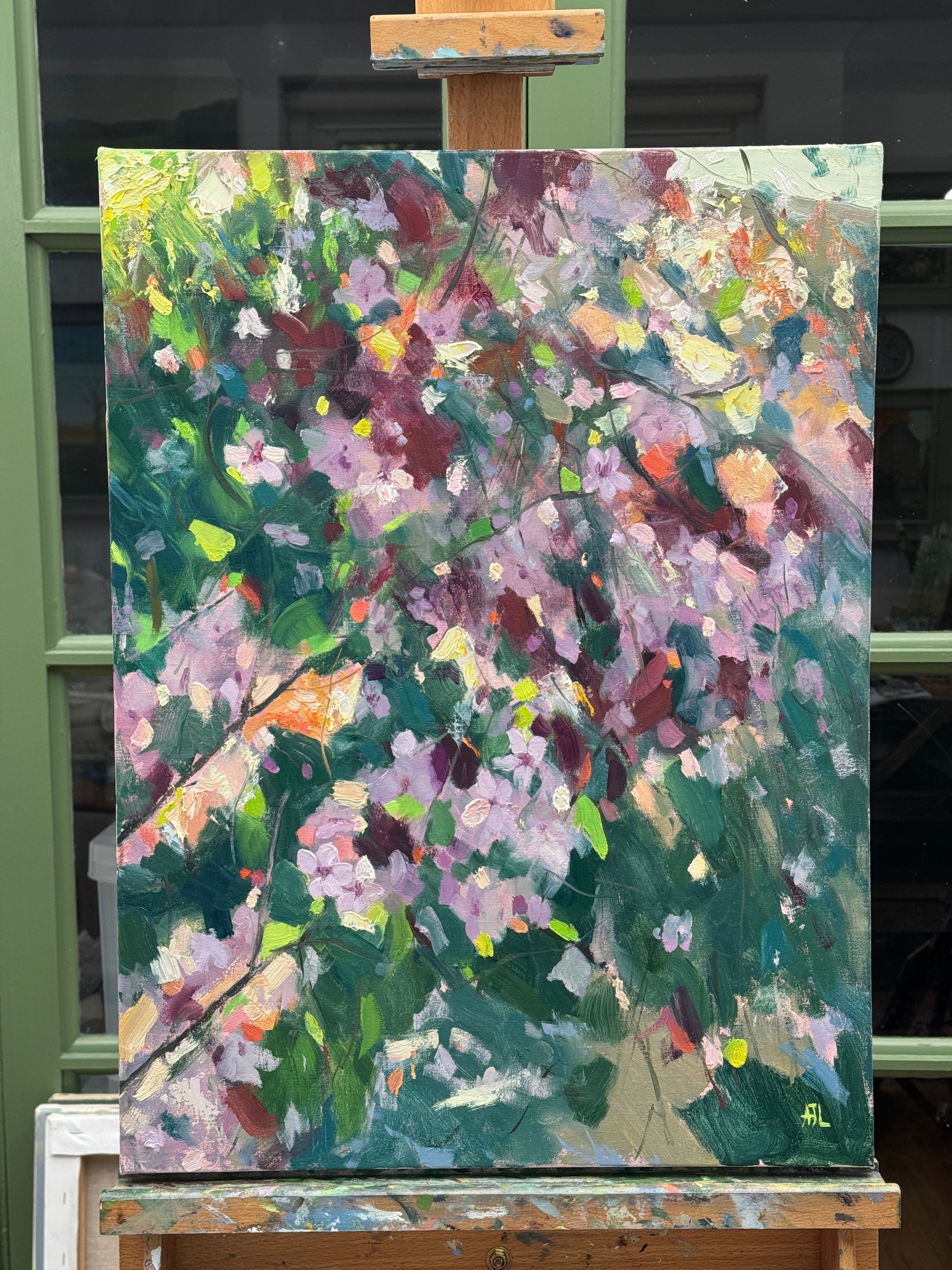 The large oil painting resting on the artist's easel.