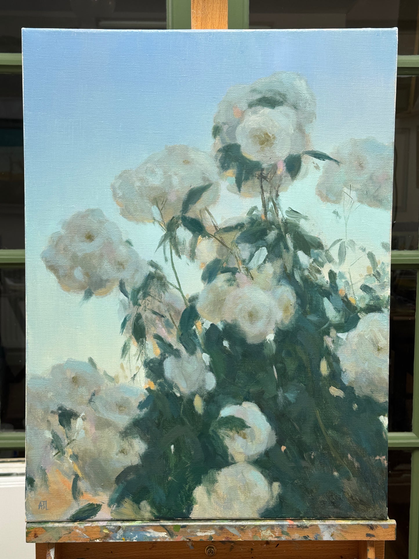The original artwork, unframed and resting on a wood artist easel.