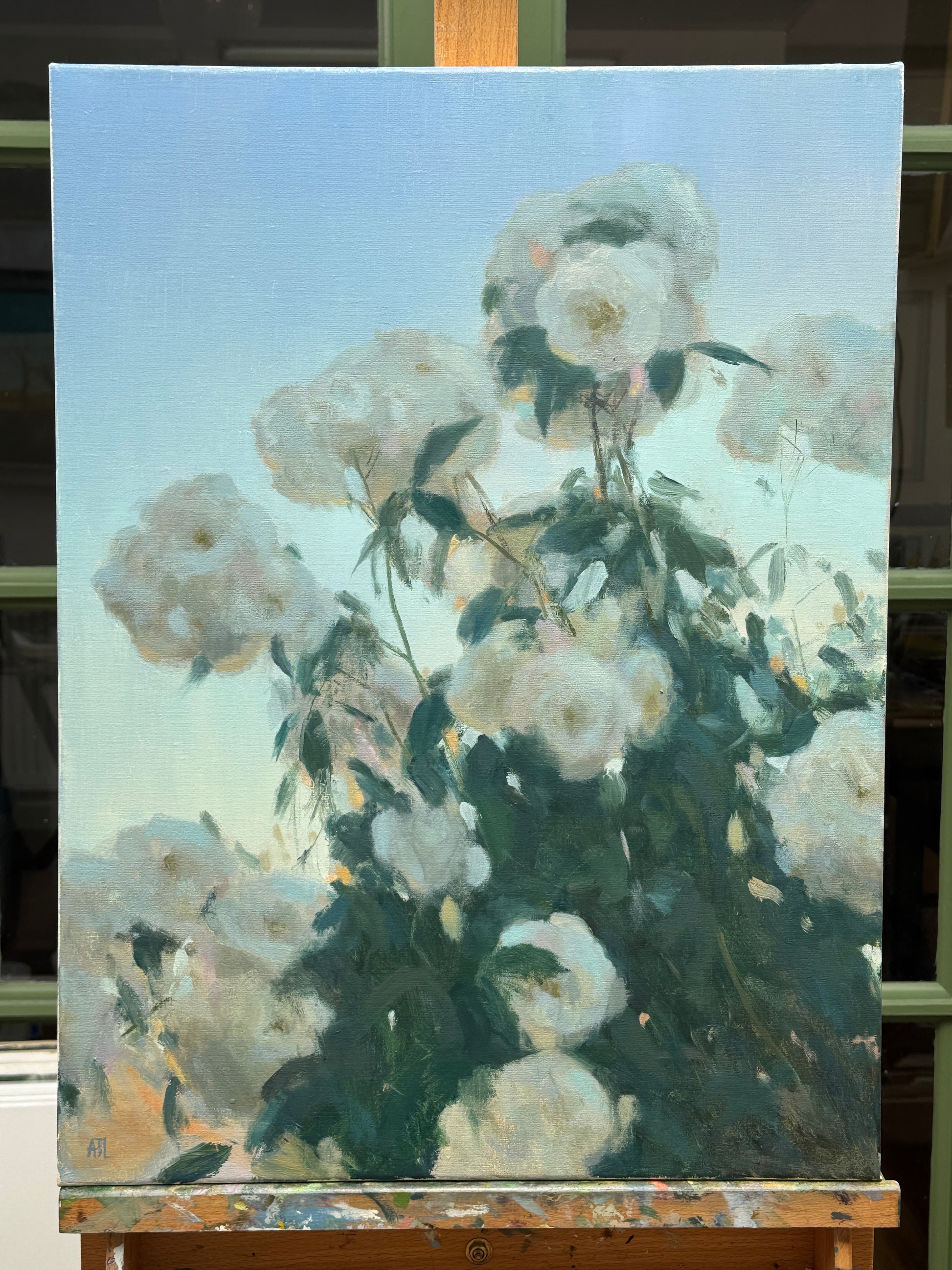 The original artwork, unframed and resting on a wood artist easel.