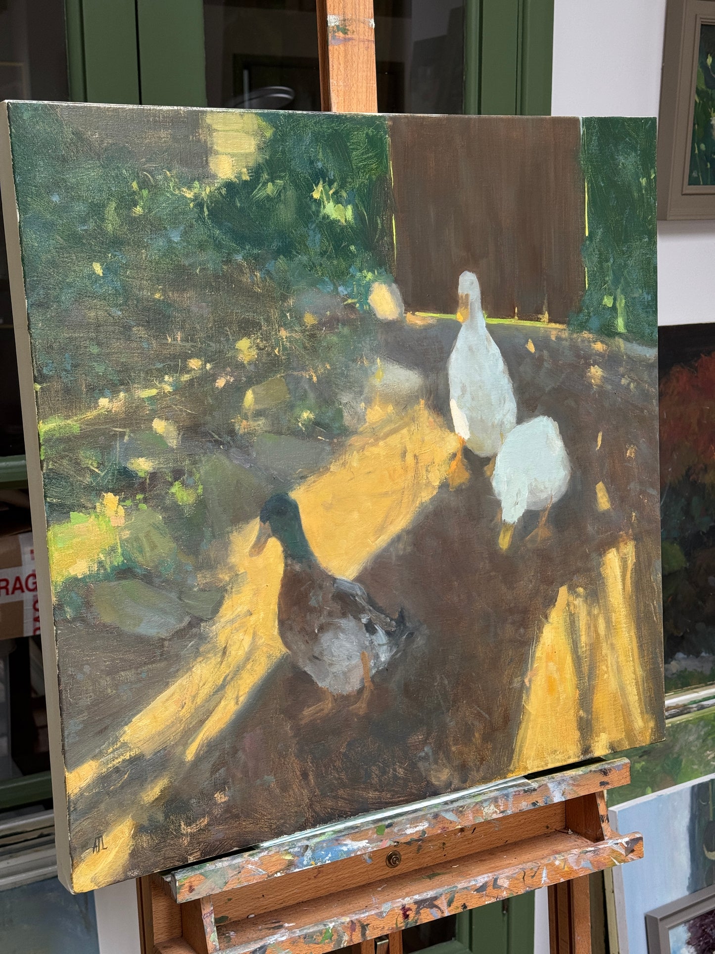 The original painting on the artist easel, side view.