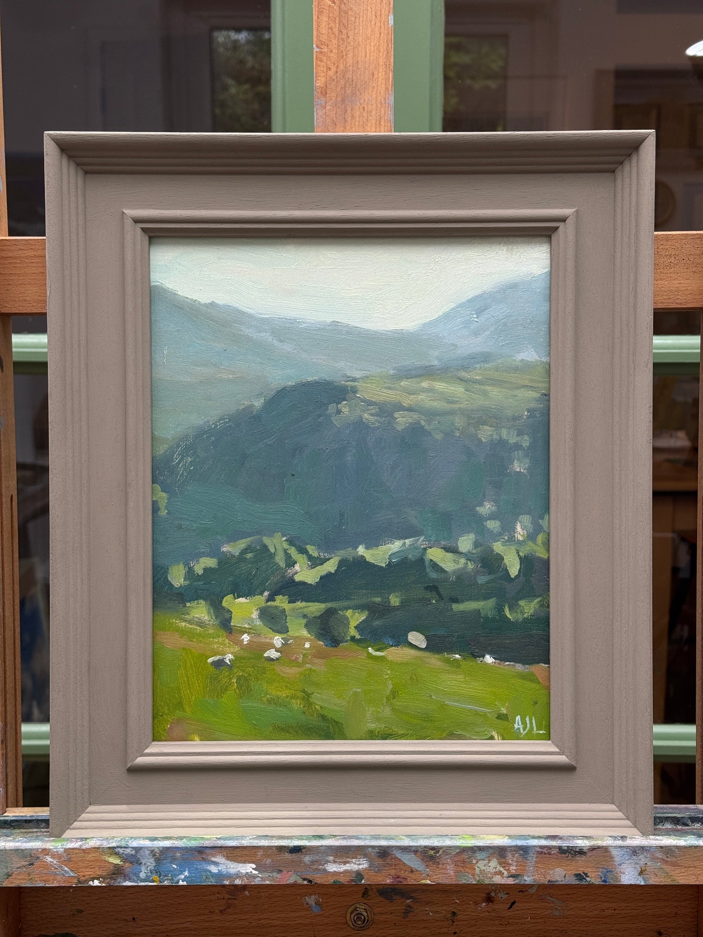 The original oil painting in a painted wooden frame.