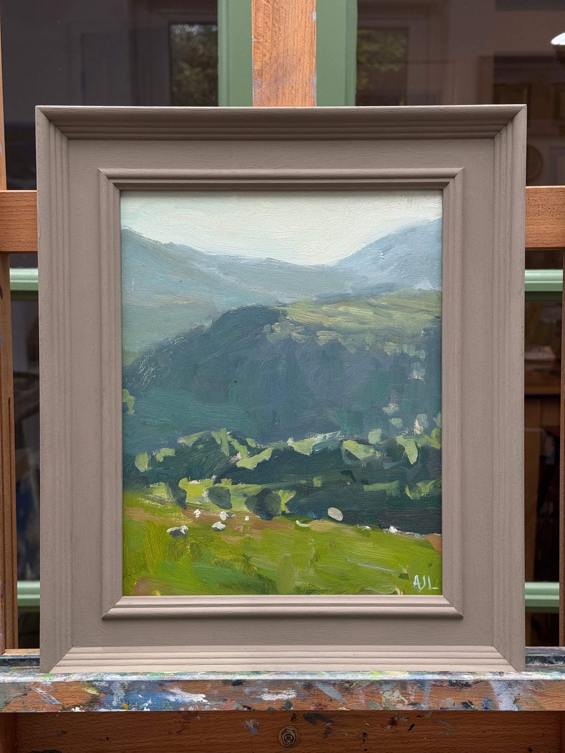 The original oil painting in a painted wooden frame.