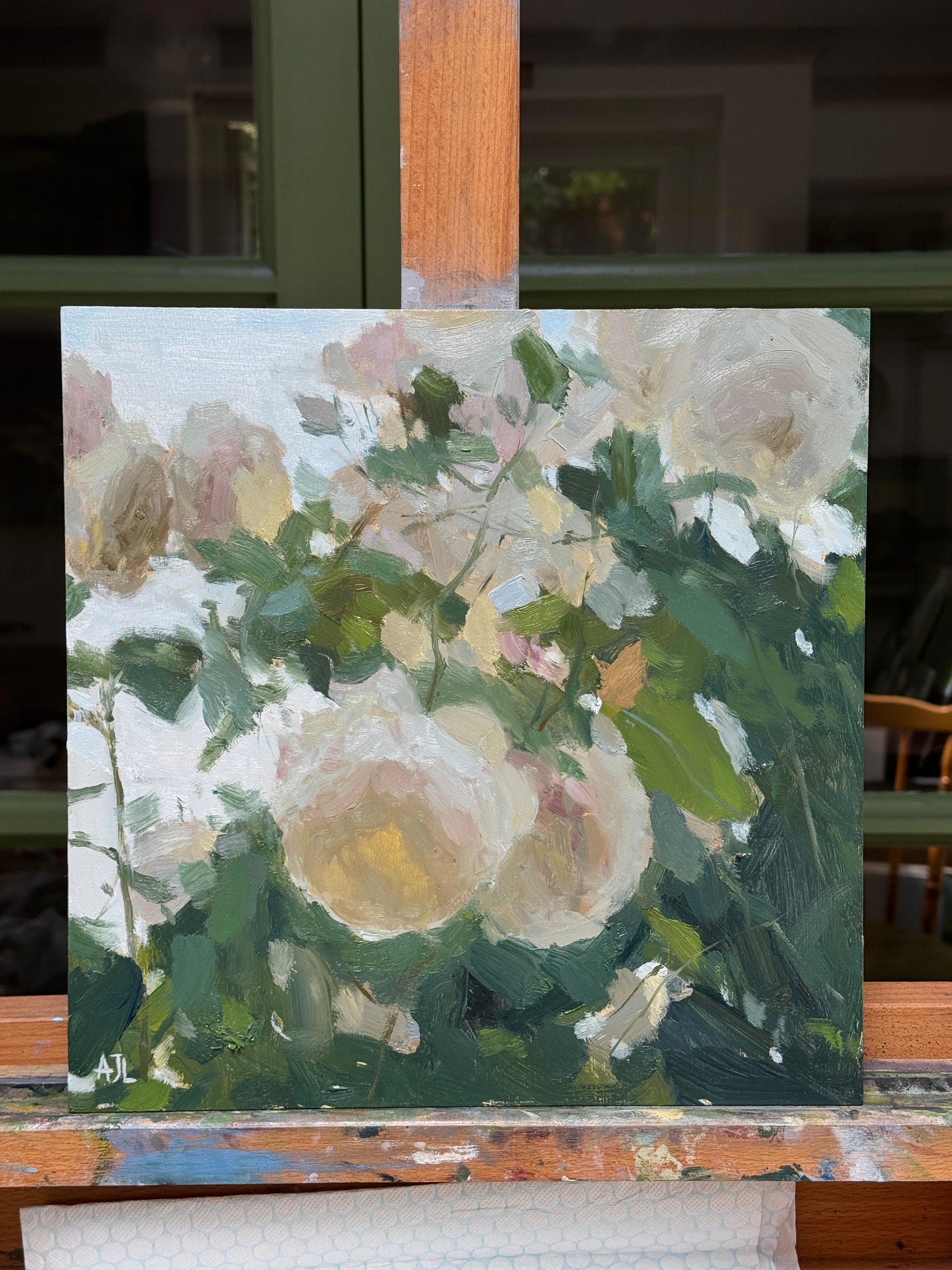 A close up of the painting on an easel.