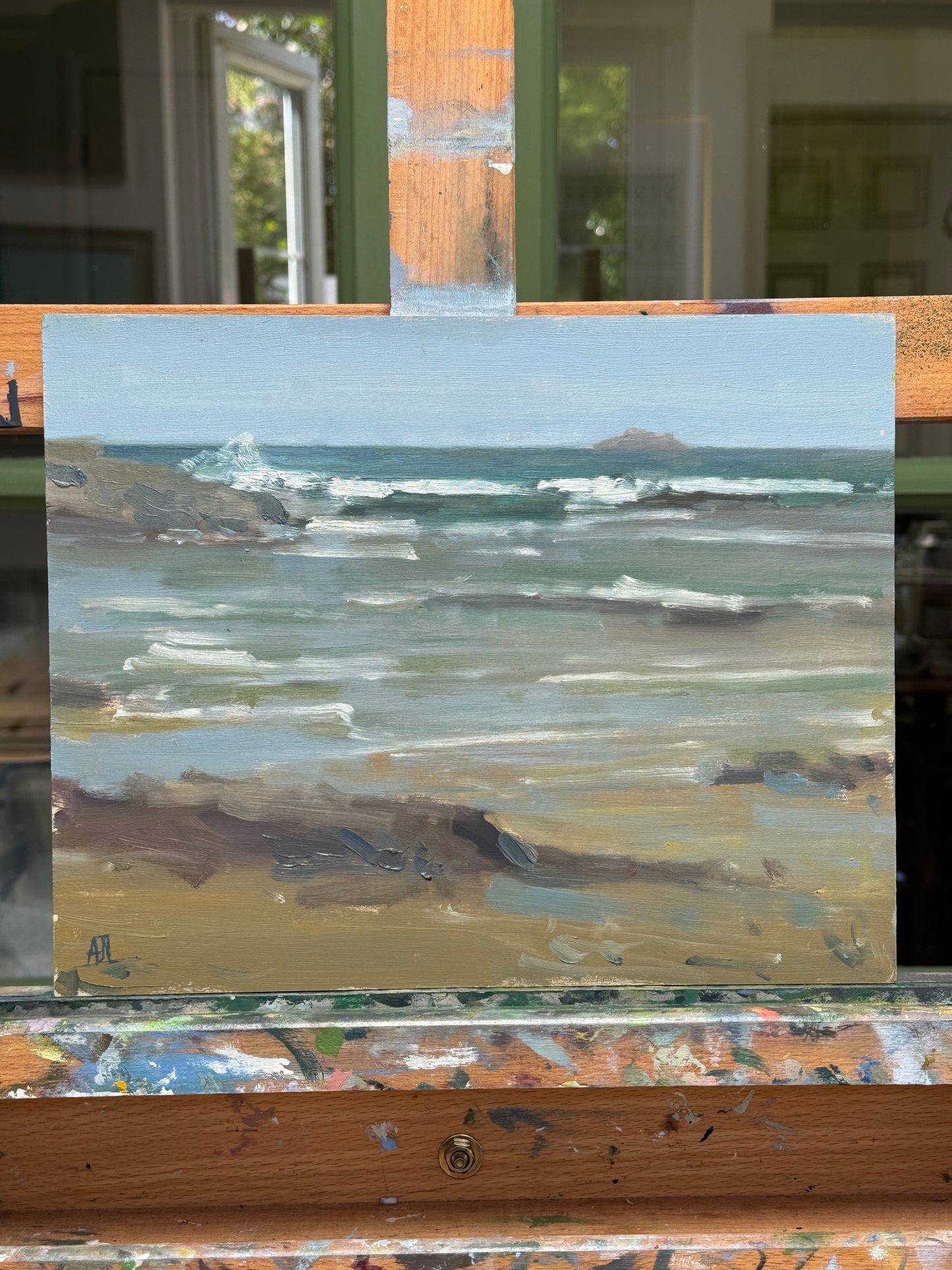 The artwork resting on the artist easel.