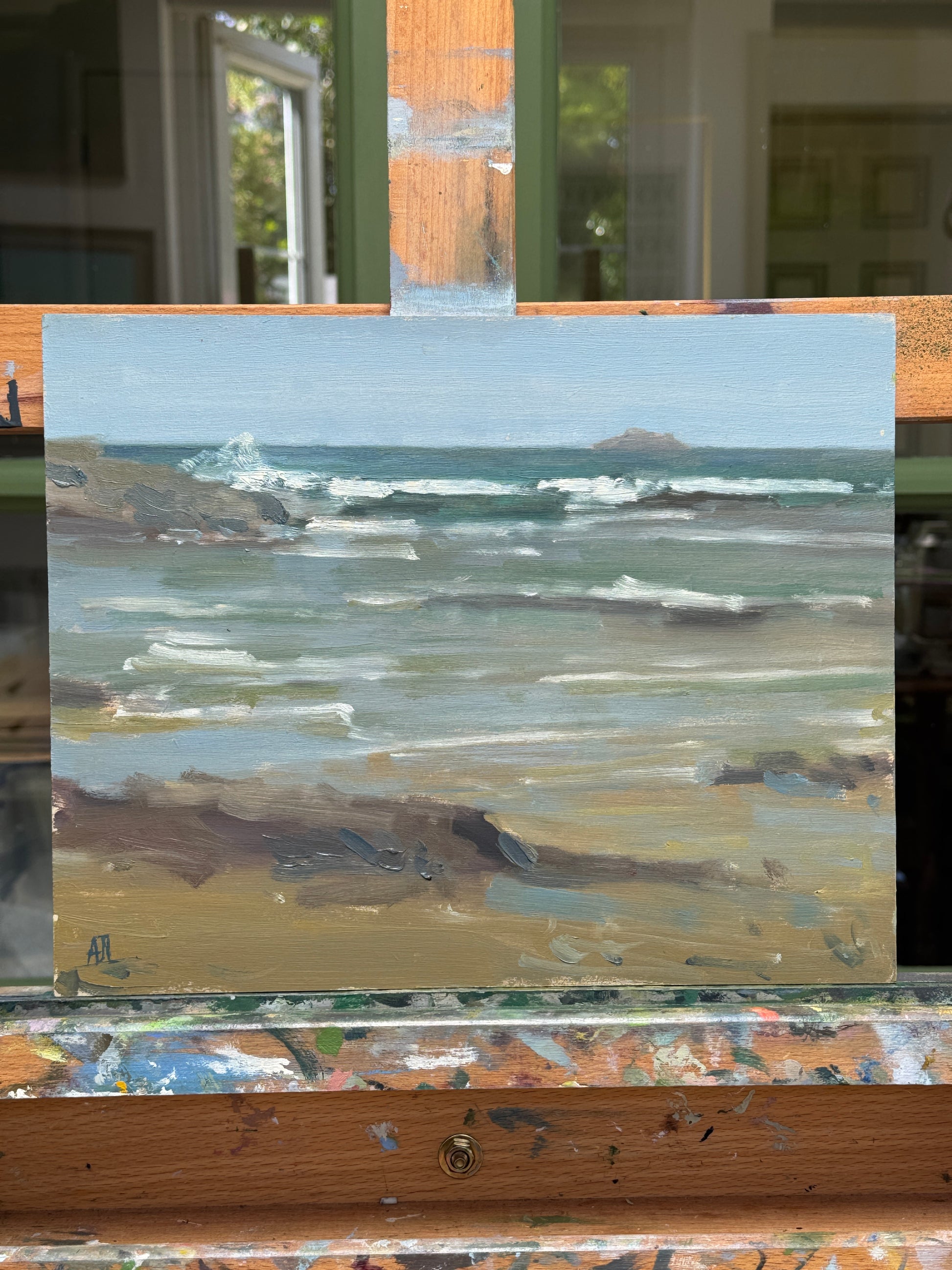 The artwork resting on the artist easel.