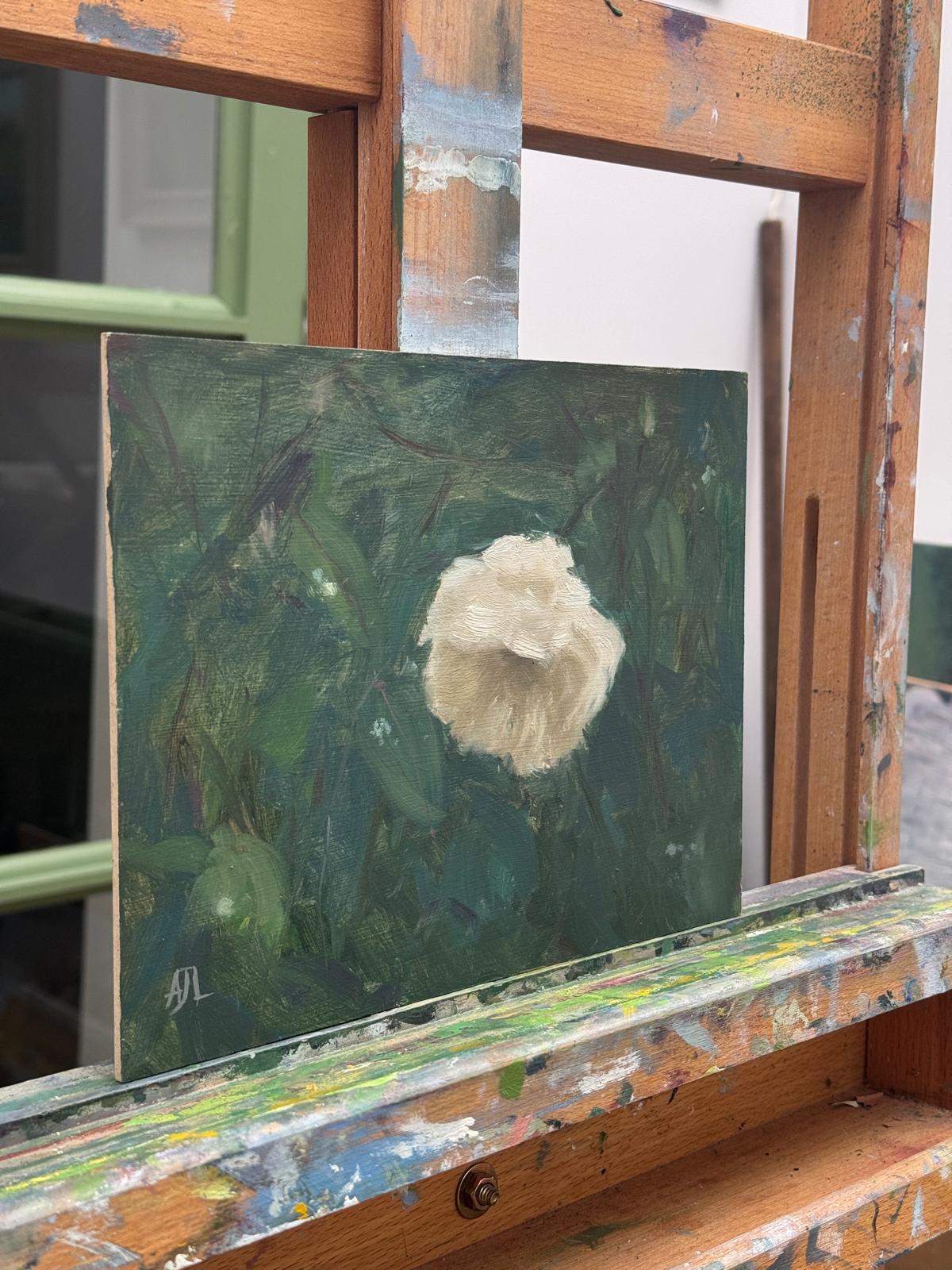 A side view of the painting on the artist easel.