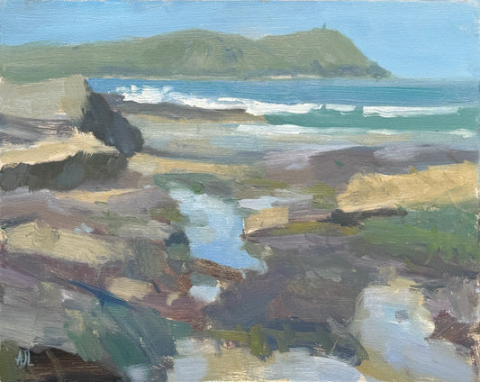 An impressionistic landscape painting of a rocky coastline with waves, a green hill in the distance, and blue sky, rendered in textured brushstrokes of blue, green, beige, brown, and white.