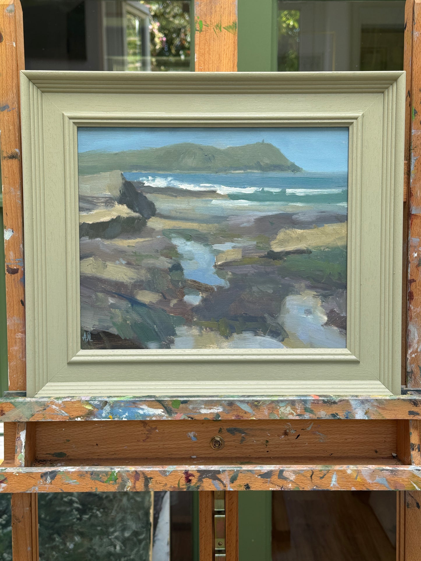 The artwork presented in a painted wooden frame.