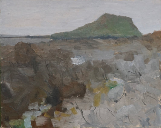 An original oil painting of rocks by the sea with an island in the background on a grey day.