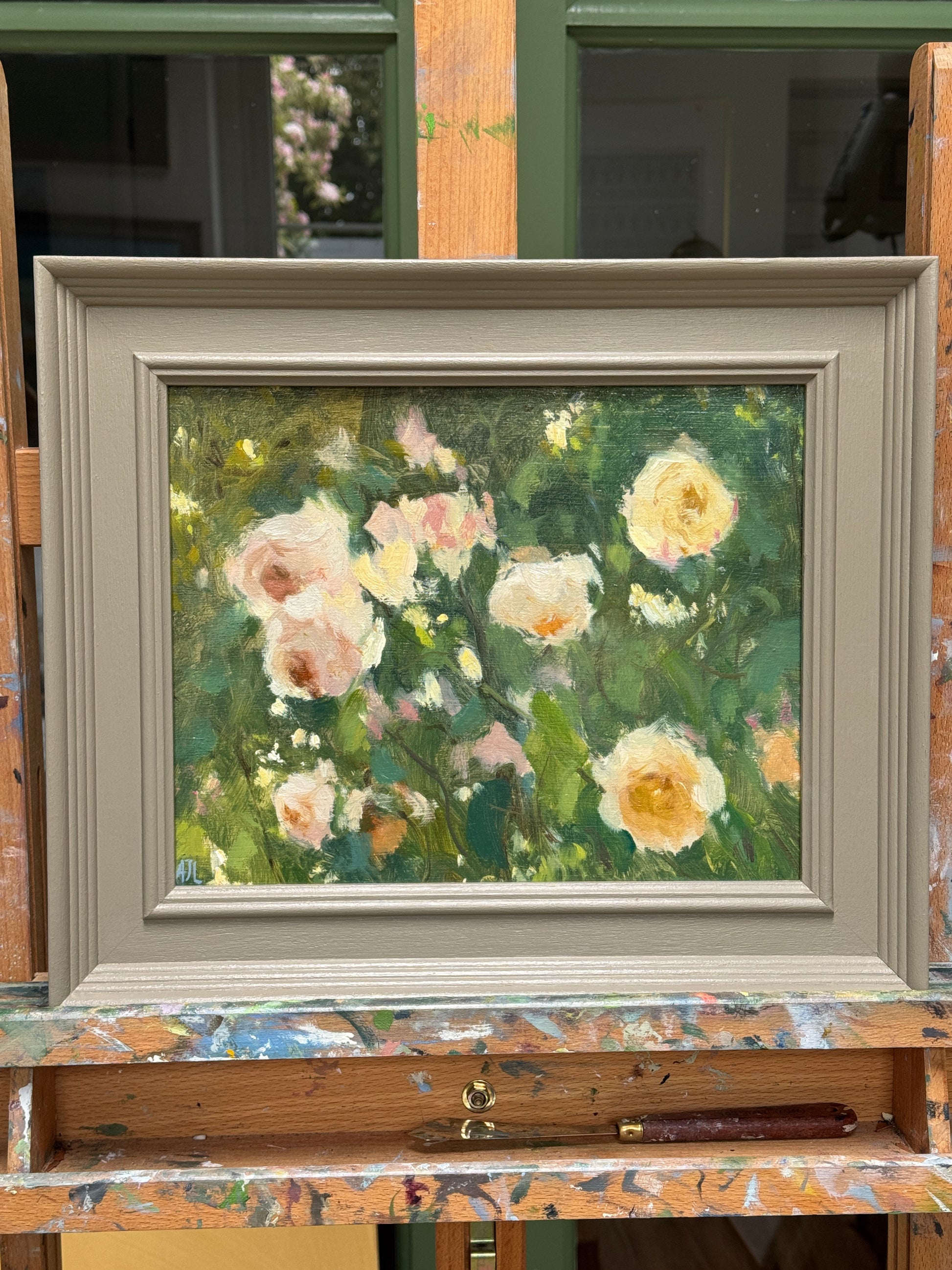 The artwork, framed an on an artist easel.