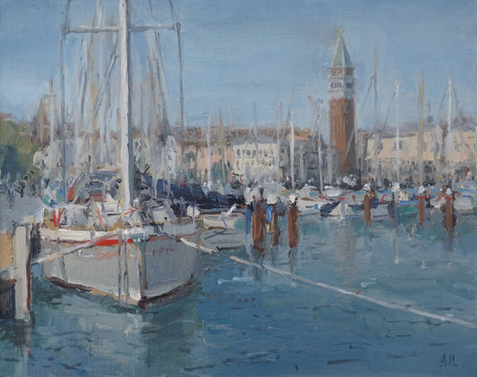 An original oil painting of boats tied up to a pier in the San Giorgio Maggiore Harbour in Venice on a cloudless blue sky afternoon. The artist has signed AJL in blue, for "Alex James Long", at the bottom right of the artwork. 
