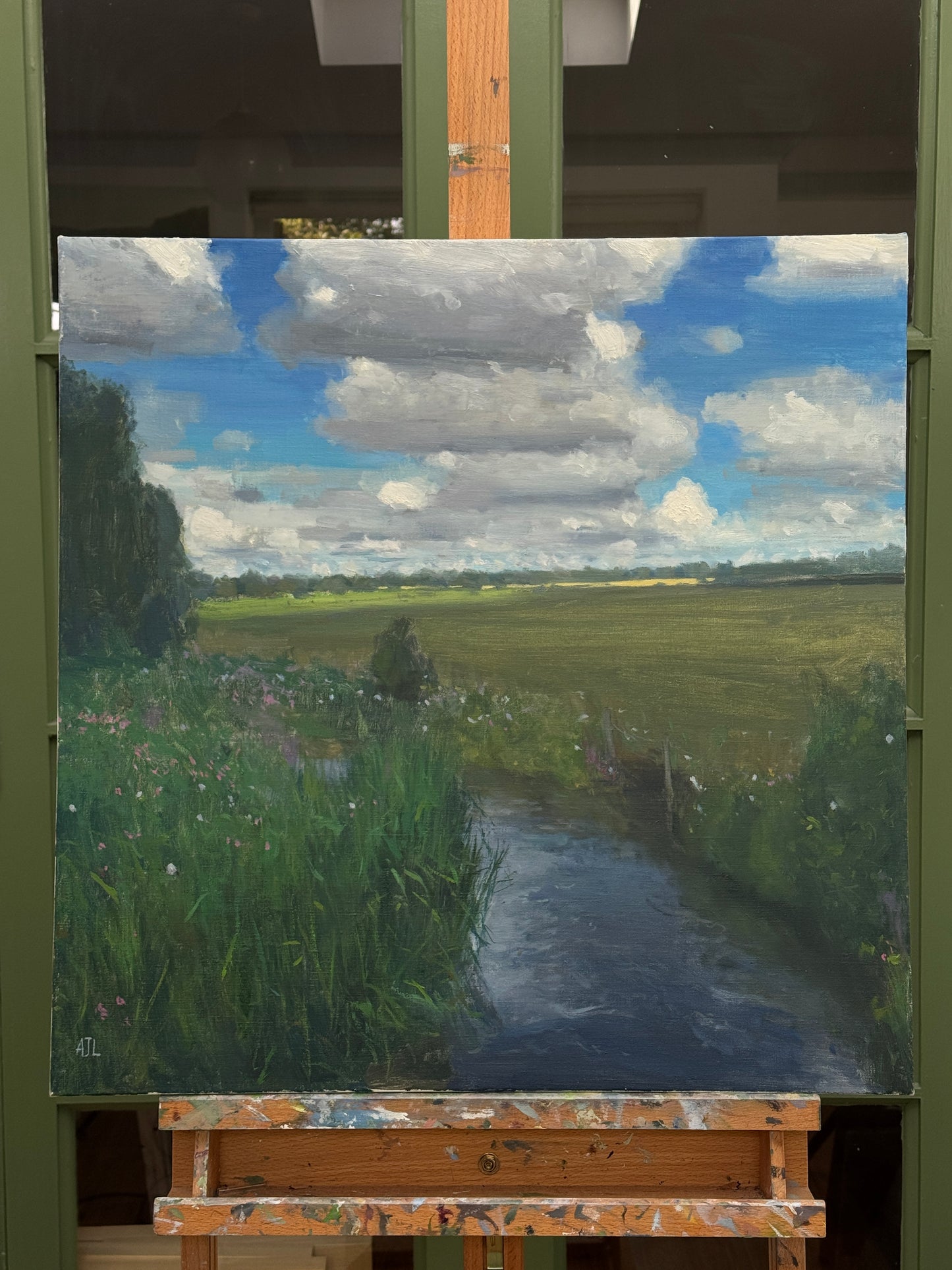 The original painting on an easel.