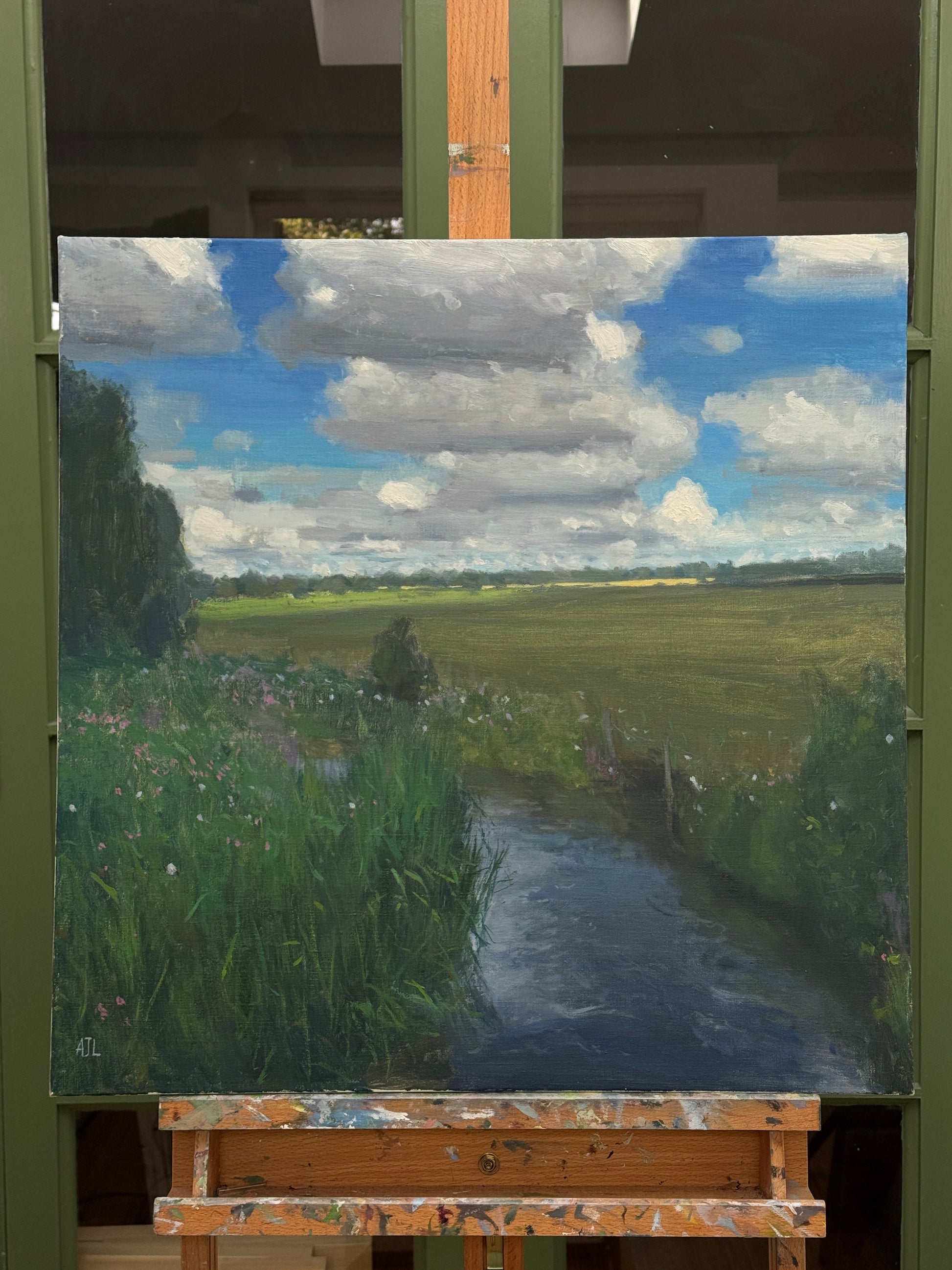 The original painting on an easel.