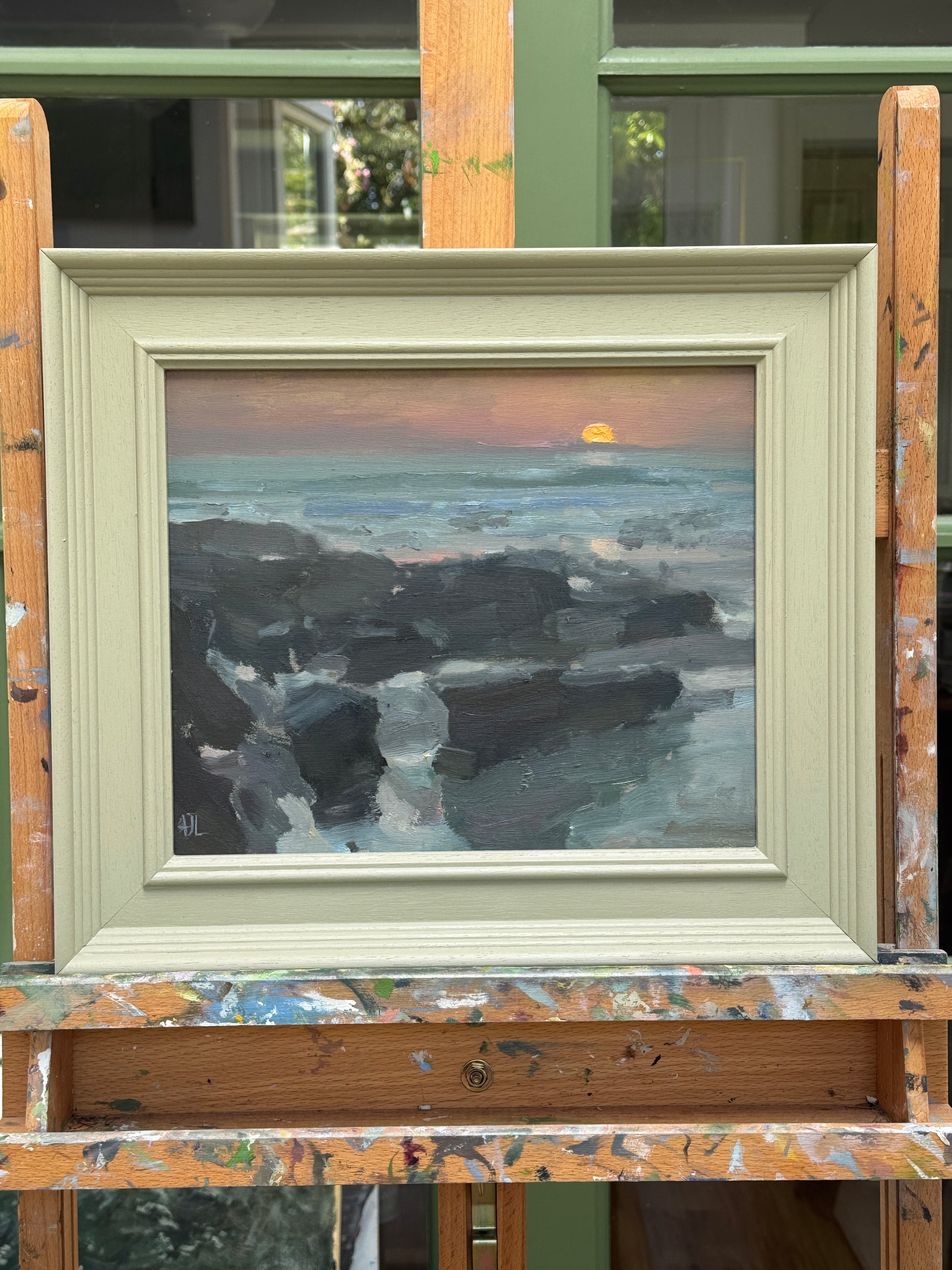 The artwork presented in a painted wooden frame.