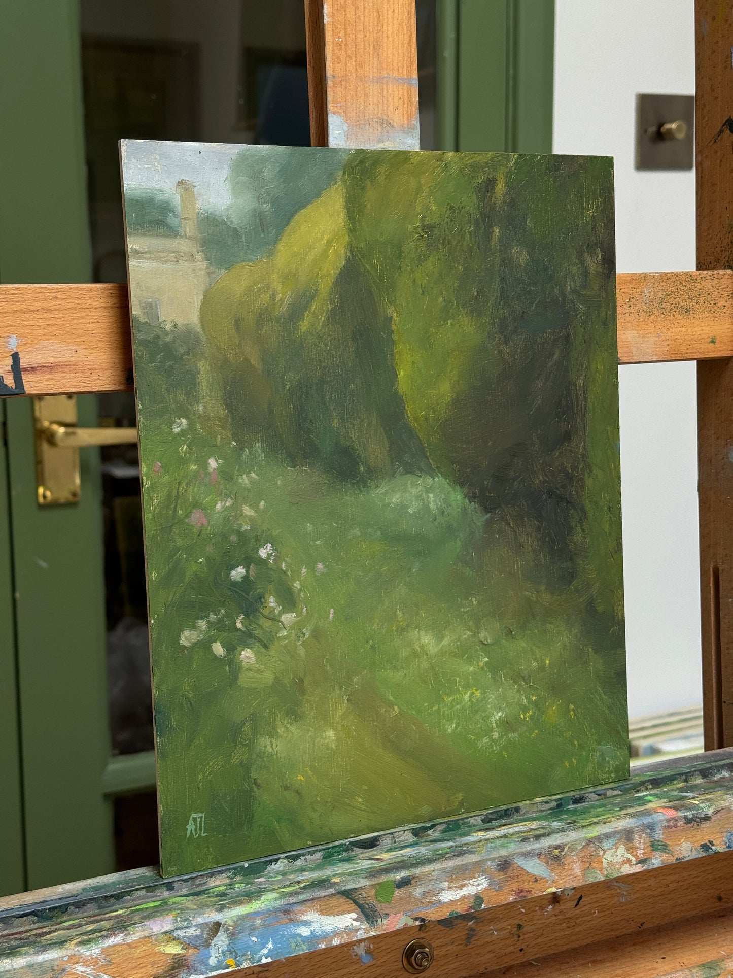 A photograph of the oil painting on the artist easel.