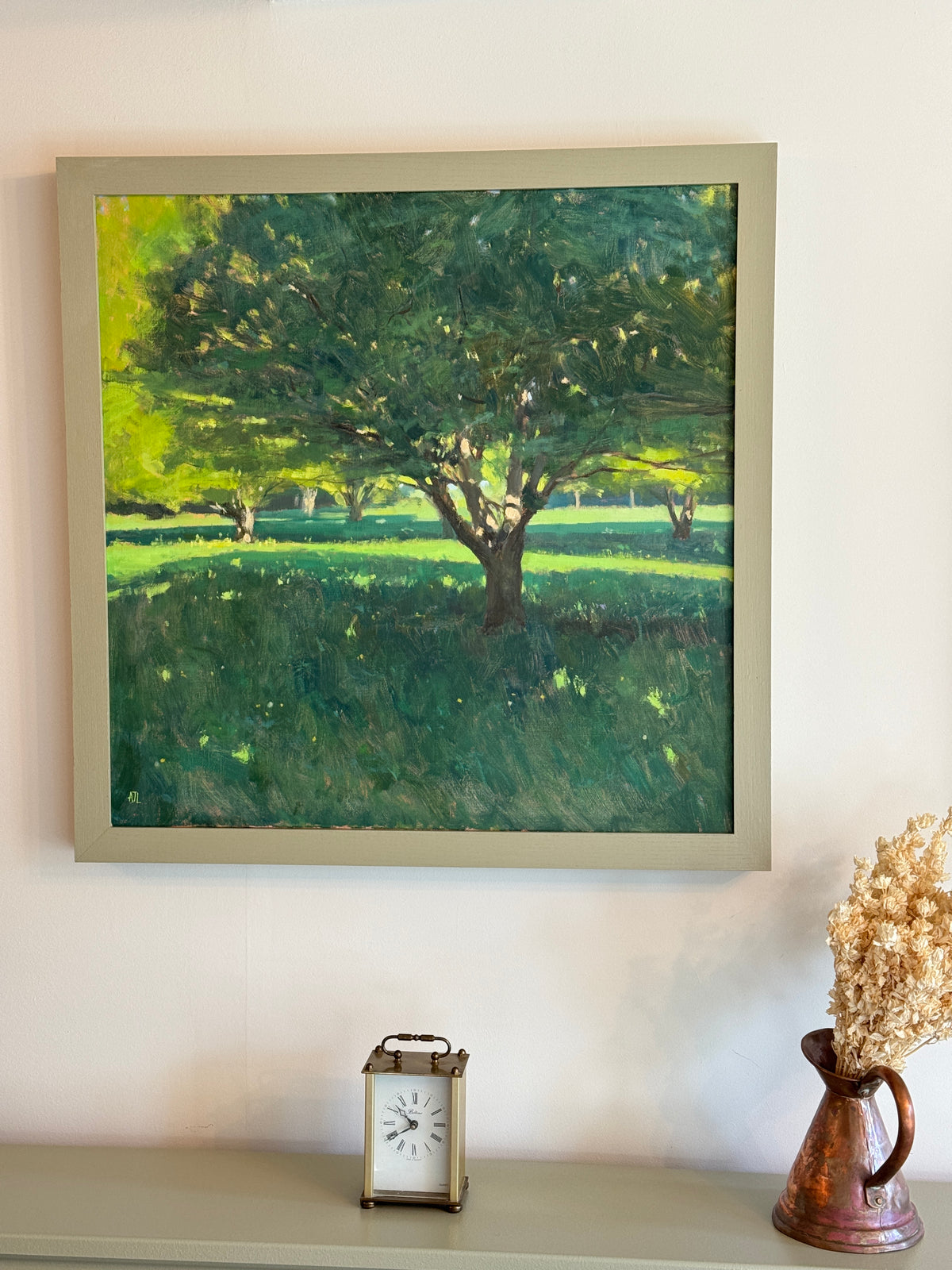 The original oil painting hanging on a white wall.