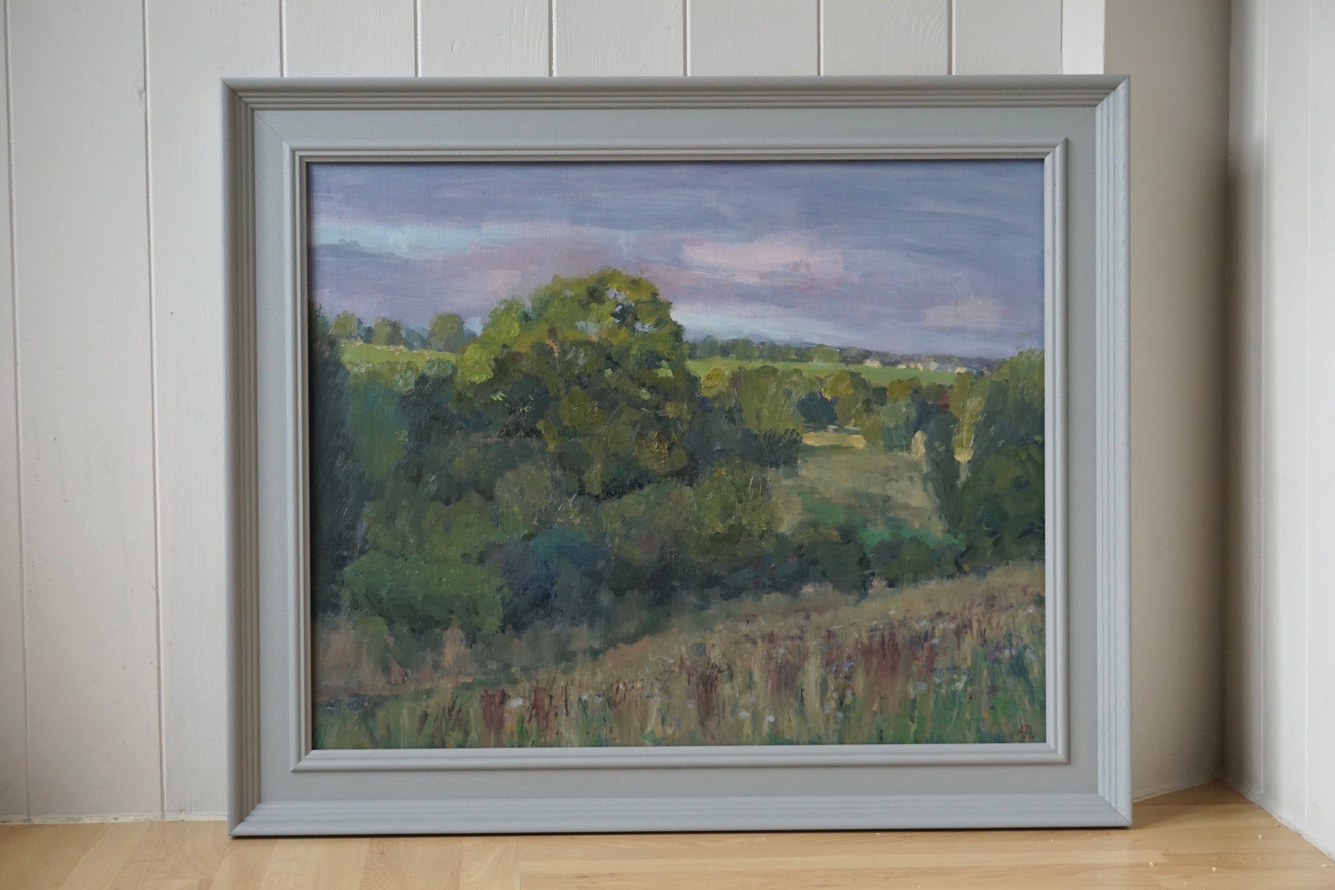 An original oil painting of a Windrush Valley field in a grey frame. 