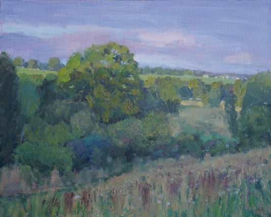 An original oil landscape painting, showing the evening light hitting a large oak tree in the near distance and fields and houses in the far distance. The artist has signed AJL in red, for "Alex James Long", at the bottom right of the artwork. 