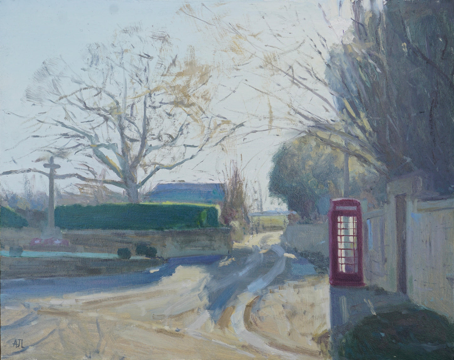 An original oil painting of a quiet winter street corner in the village of Sherborne, with a war memorial on one side of the street and a red phone box by a tall Cotswold stone wall on the other. The artist has signed AJL, for "Alex James Long", at the bottom left of the artwork. 