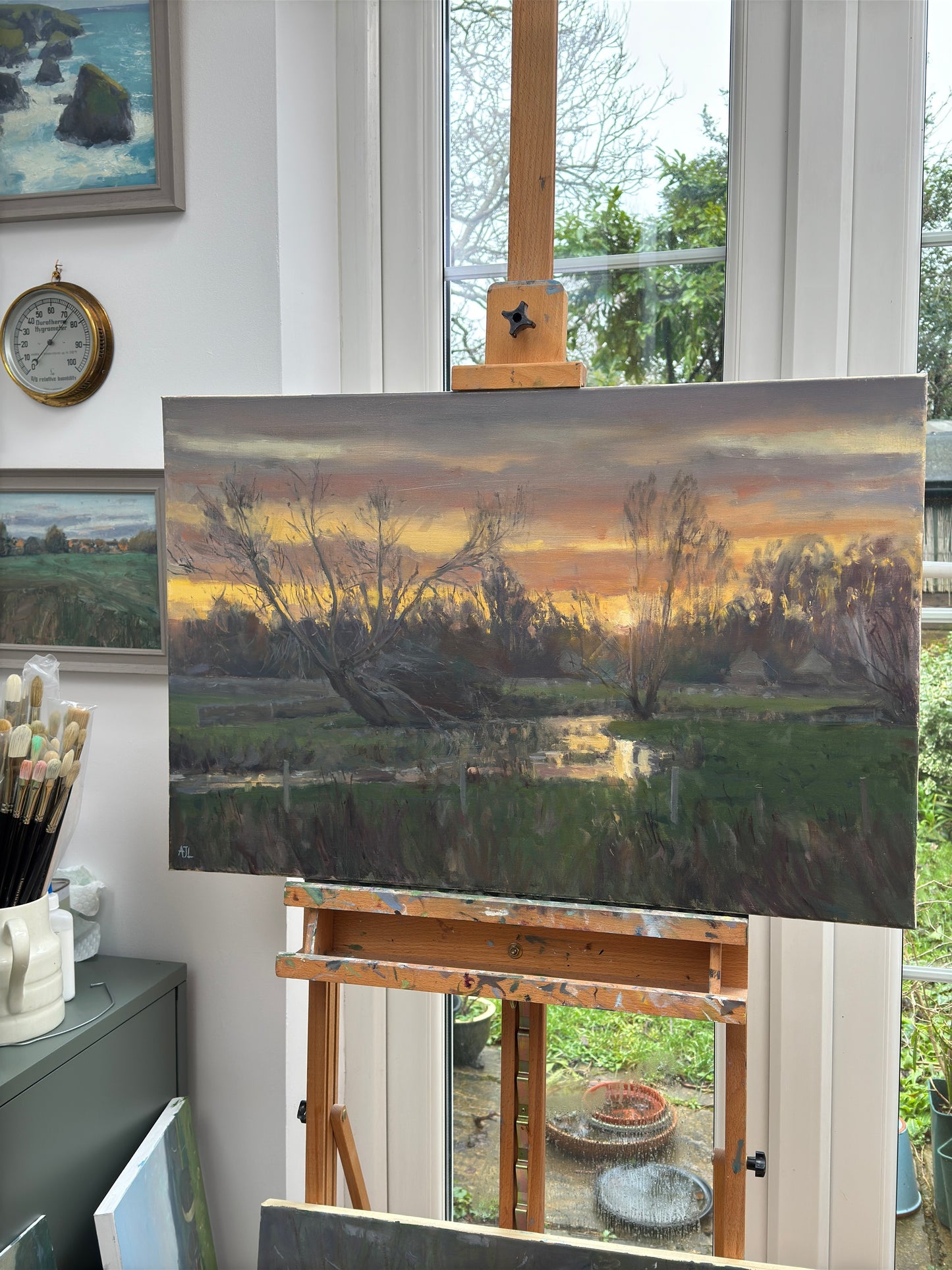 The painting in the artist's studio, on an easel.