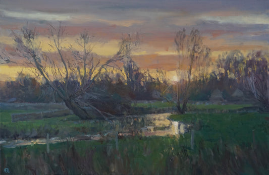 An original oil painting of the River Windrush just as the sun sets above a shadowy line of trees; the vibrant colours of the sky are reflected in the winding river below. The artist has signed AJL in blue, for "Alex James Long", at the bottom left of the artwork.